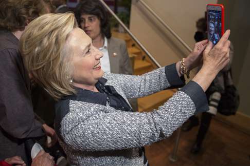epa05364991 US Democratic presidential candidate Hillary Clinton takes a selfie at a campaign event in Pittsburgh, Pennsylvania, USA, 14 June 2016. Clinton criticized Republican presidential candidate Donald Trump's response to the 12 June mass shooting in Orlando, Florida. EPA/MICHAEL REYNOLDS