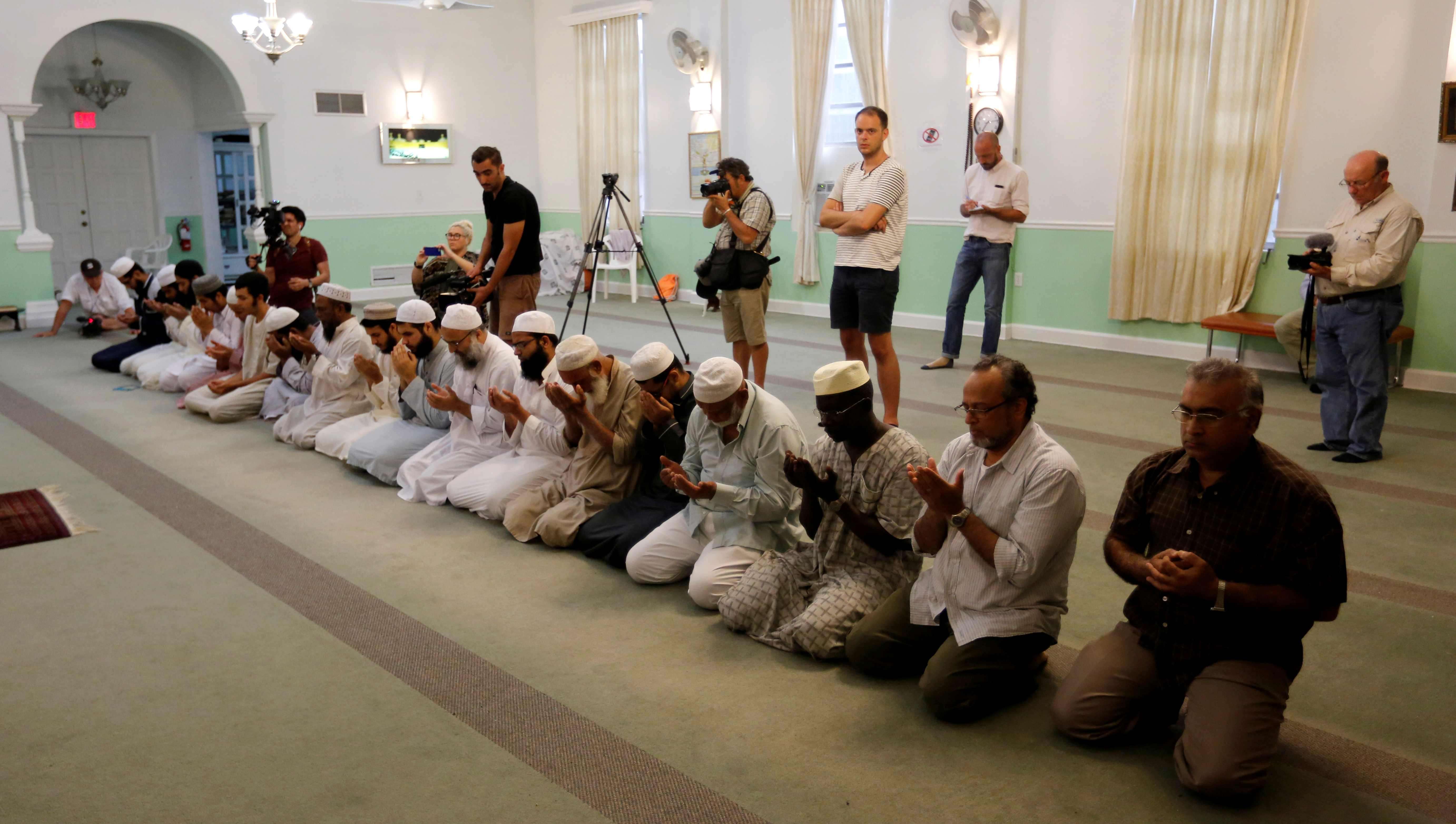 Worshippers listen as Imam Syed Shafeeq Rahman of the Islamic Centre of Fort Pierce offers a prayer for victims of the Orlando shooting, in Fort Pierce on Sunday. Photo: Reuters