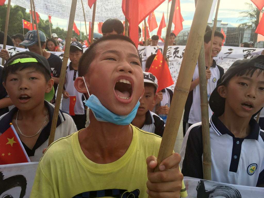 Wukan villagers including schoolchildren take part in a protest march, demanding the release of their village chief Lin Zuluan. Photo: Reuters