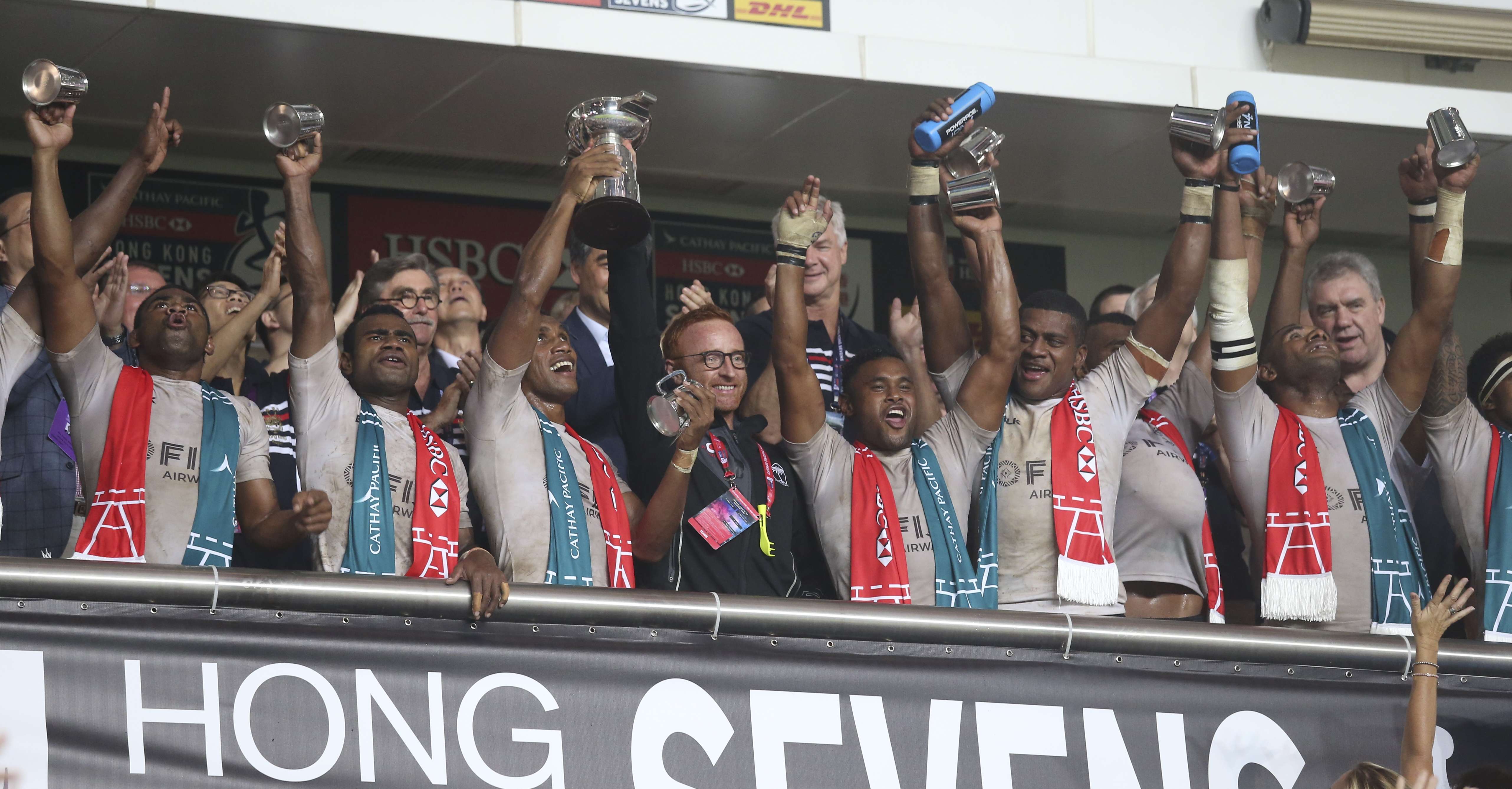 Fiji's players including captain Osea Kolinisau and coach Ben Ryan holding the trophy as they celebrate the Cup final win during the Cathay Pacific/HSBC Hong Kong Sevens 2016. Photos: SCMP