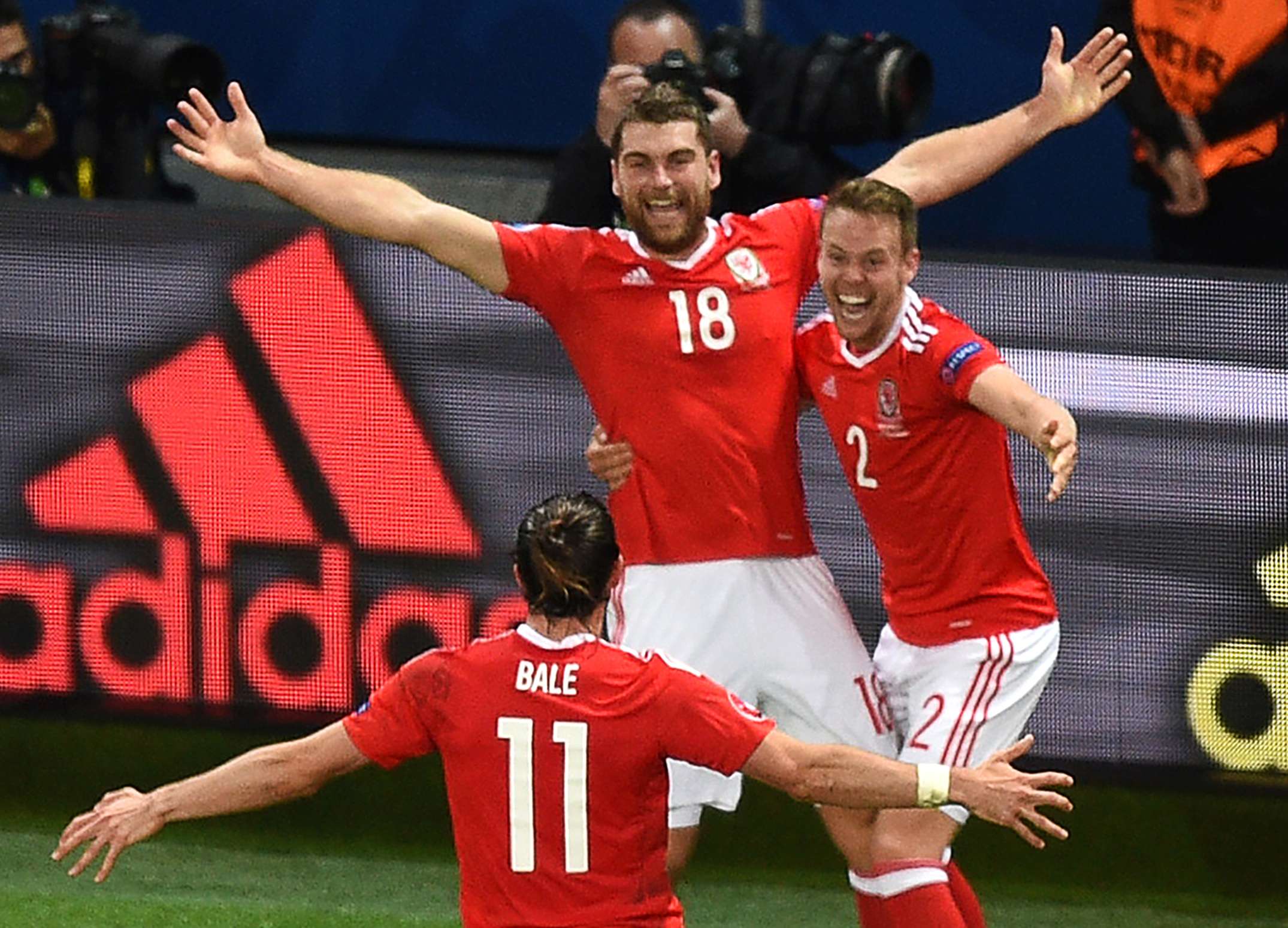 Wales' forward Sam Vokes (C) celebrates with teammates after scoring the killer third AFP PHOTO / DENIS CHARLET
