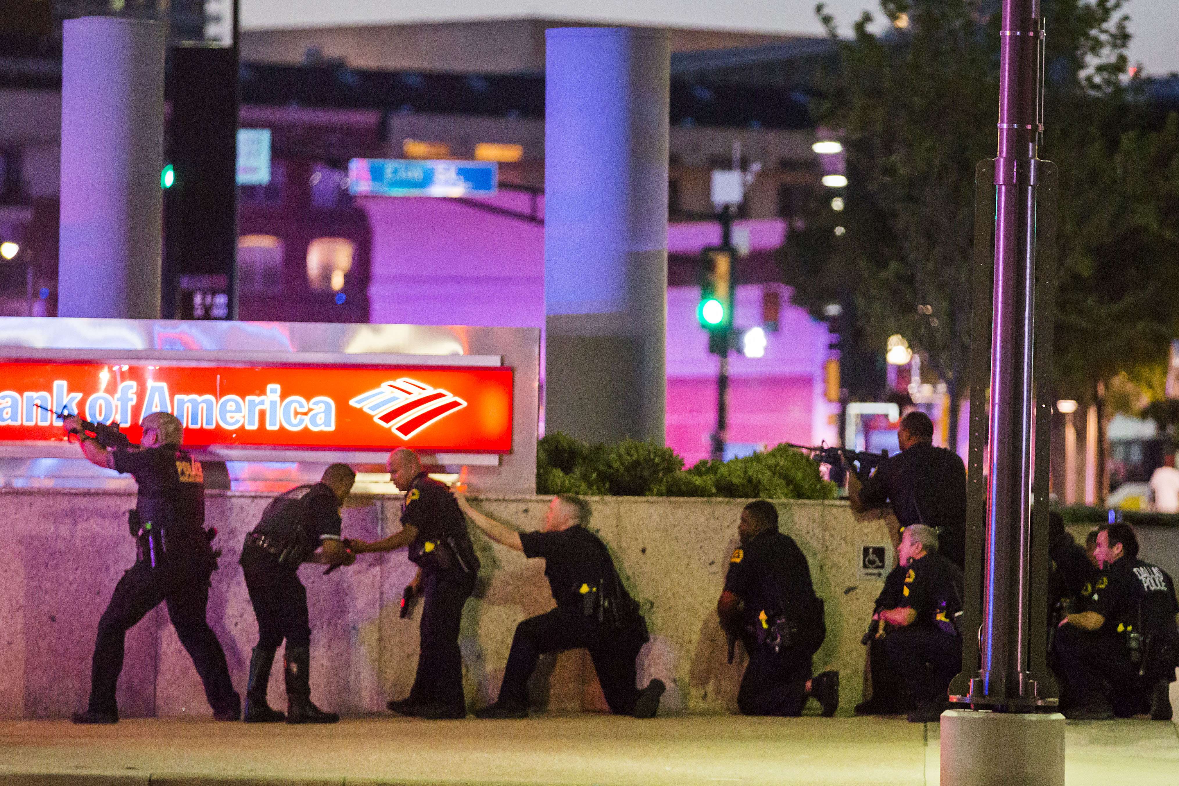 Dallas police take cover after shots were fired at a Black Lives Matter rally in downtown Dallas on Thursday, July 7, 2016. Photo: The Dallas Morning News