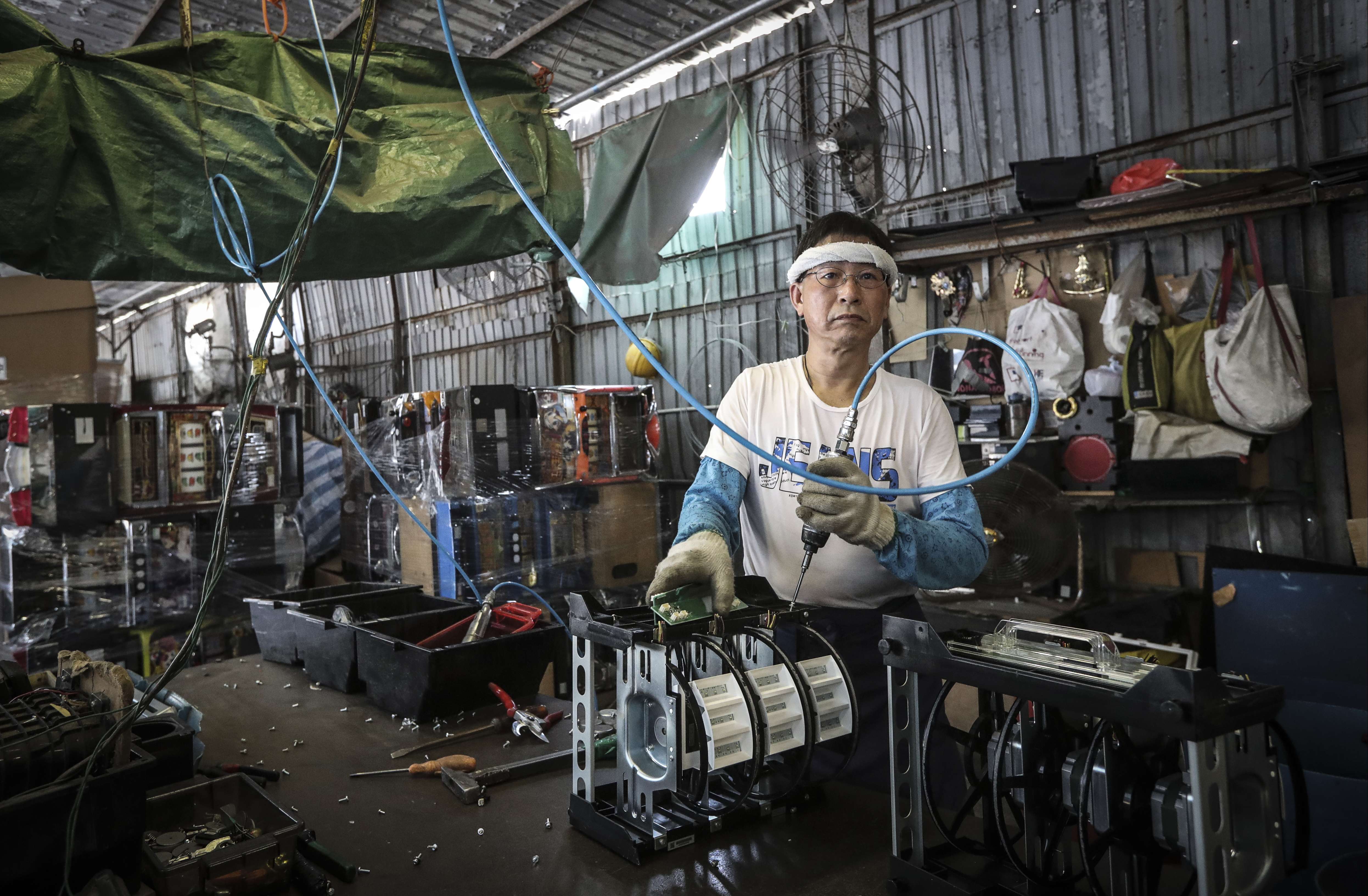 A worker at an e-waste dumping ground in Yuen Long. Photo: Bruce Yan