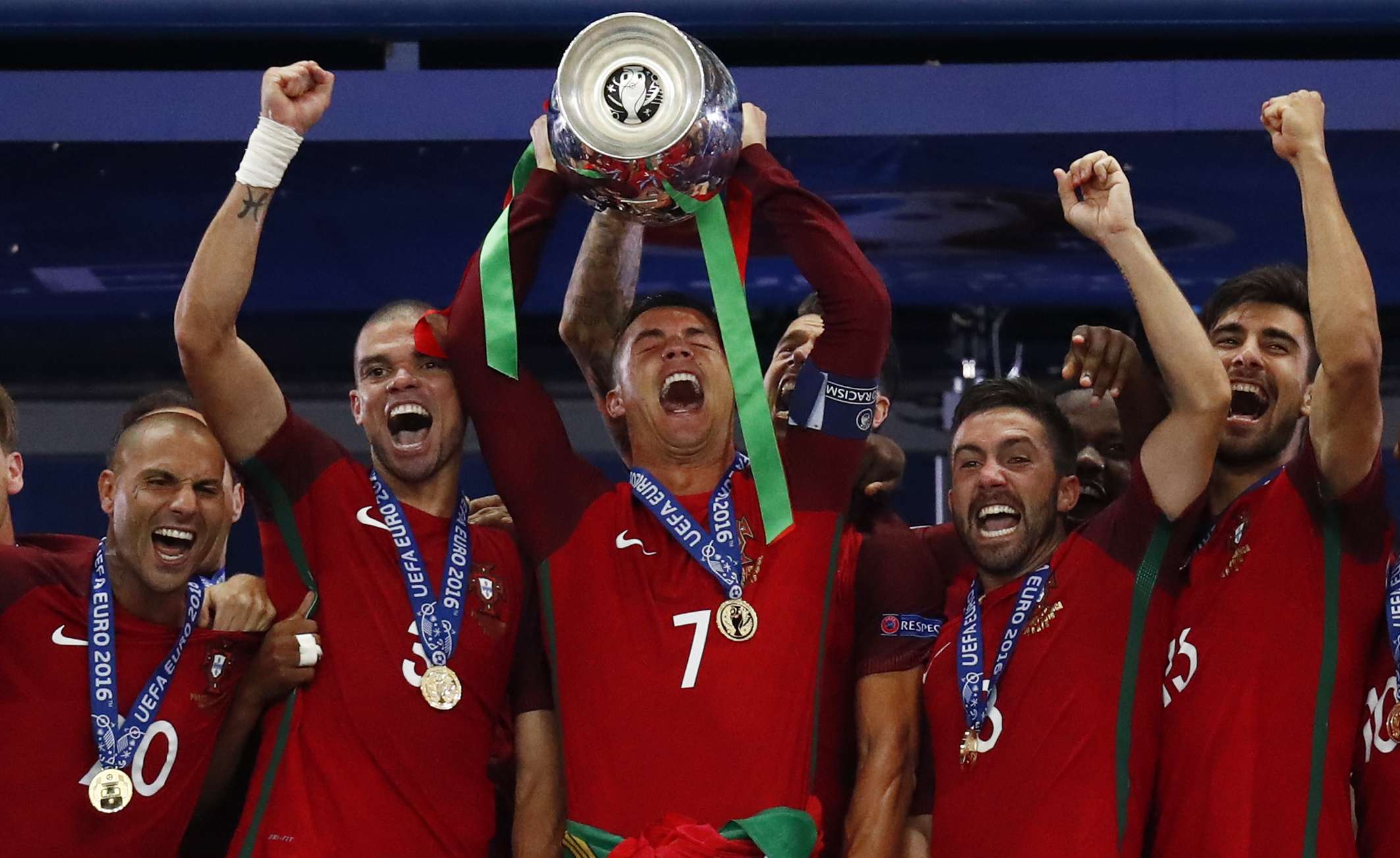 Portugal's Cristiano Ronaldo celebrates with team mates and the trophy after winning Euro 2016 REUTERS/Kai Pfaffenbach Livepic