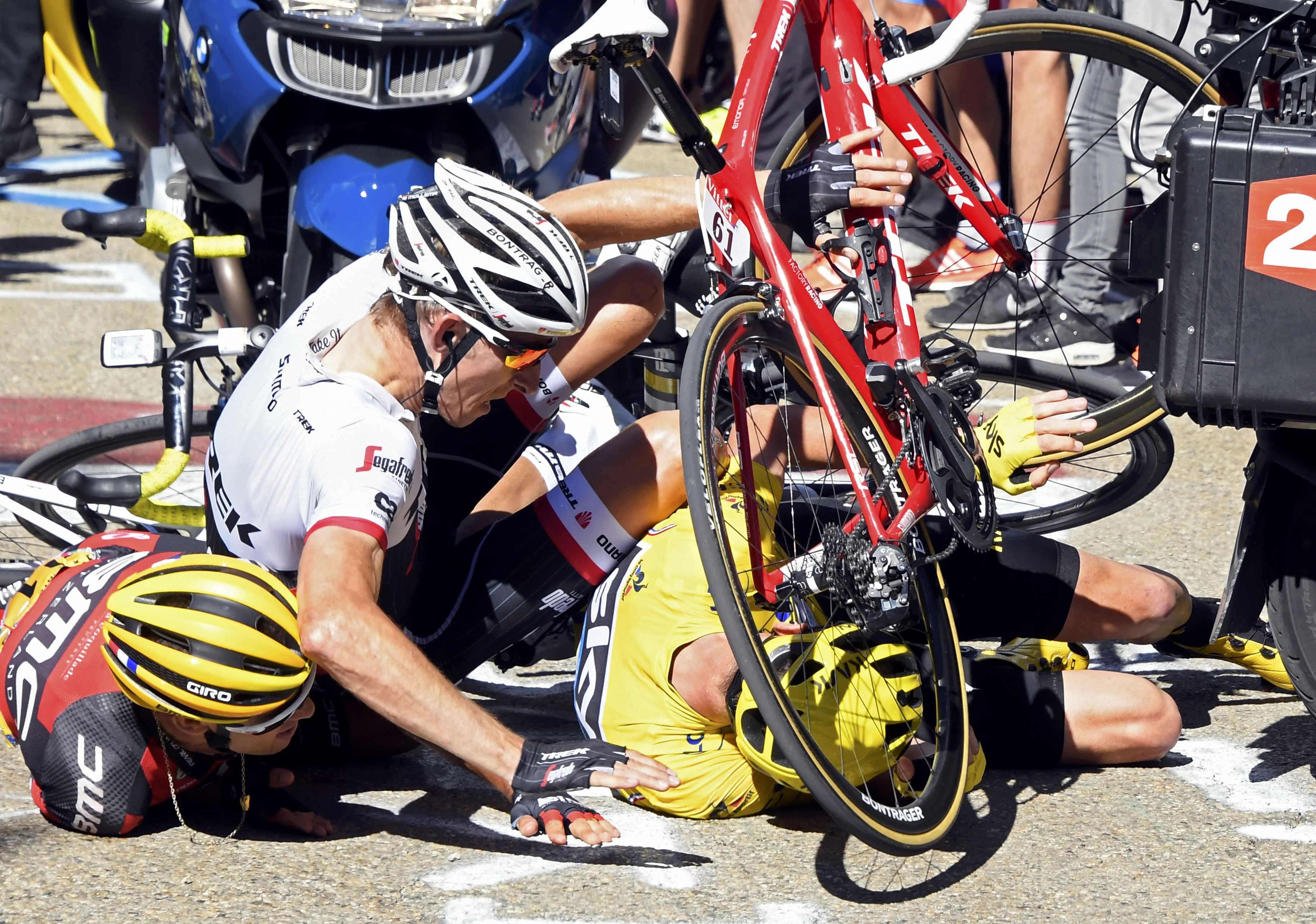 Chris Froome hits the ground in his yellow jersey. Photo: Reuters