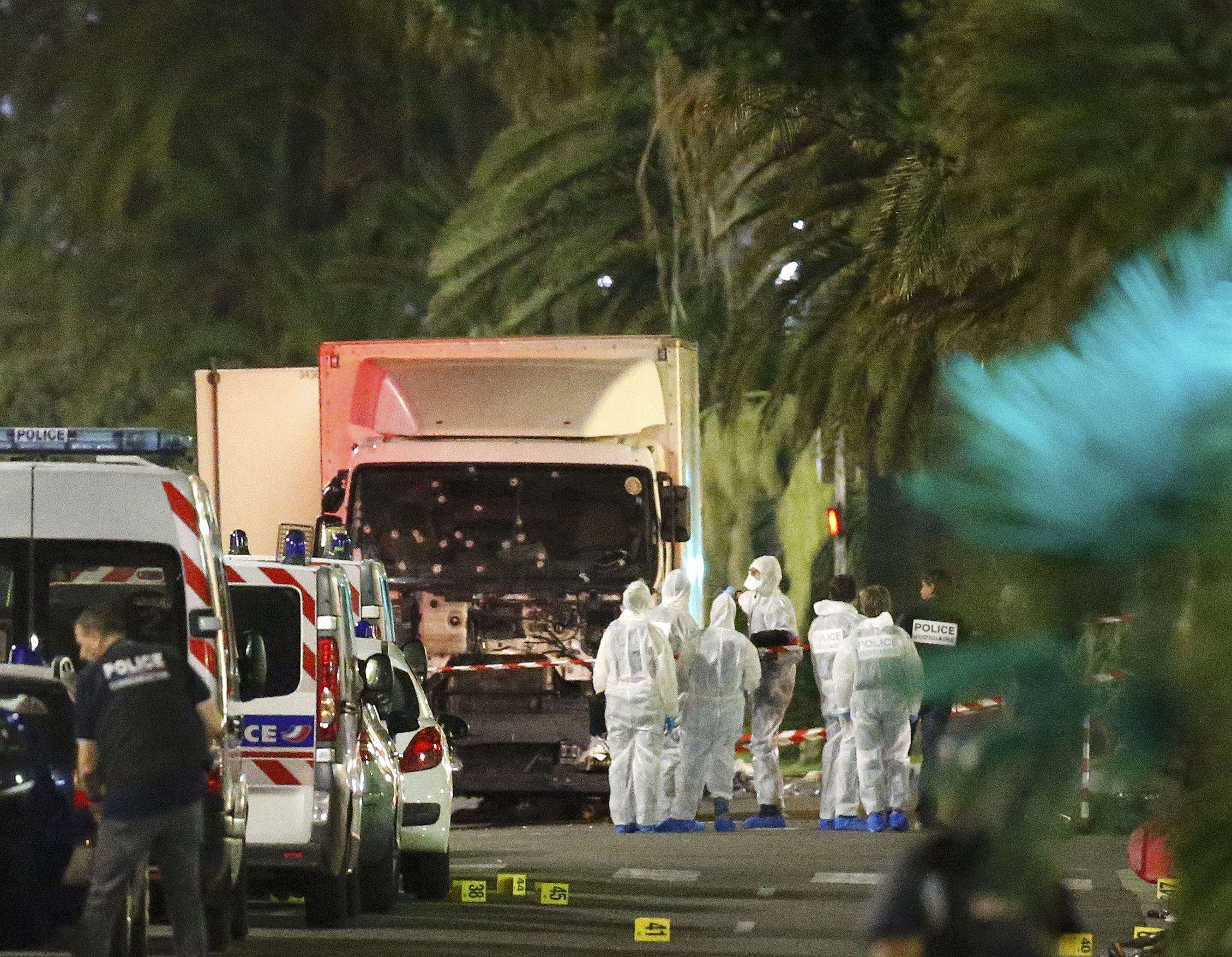 French police and forensic officers stand next to the truck used in the Bastille Day attack in Nice. Photo: Reuters