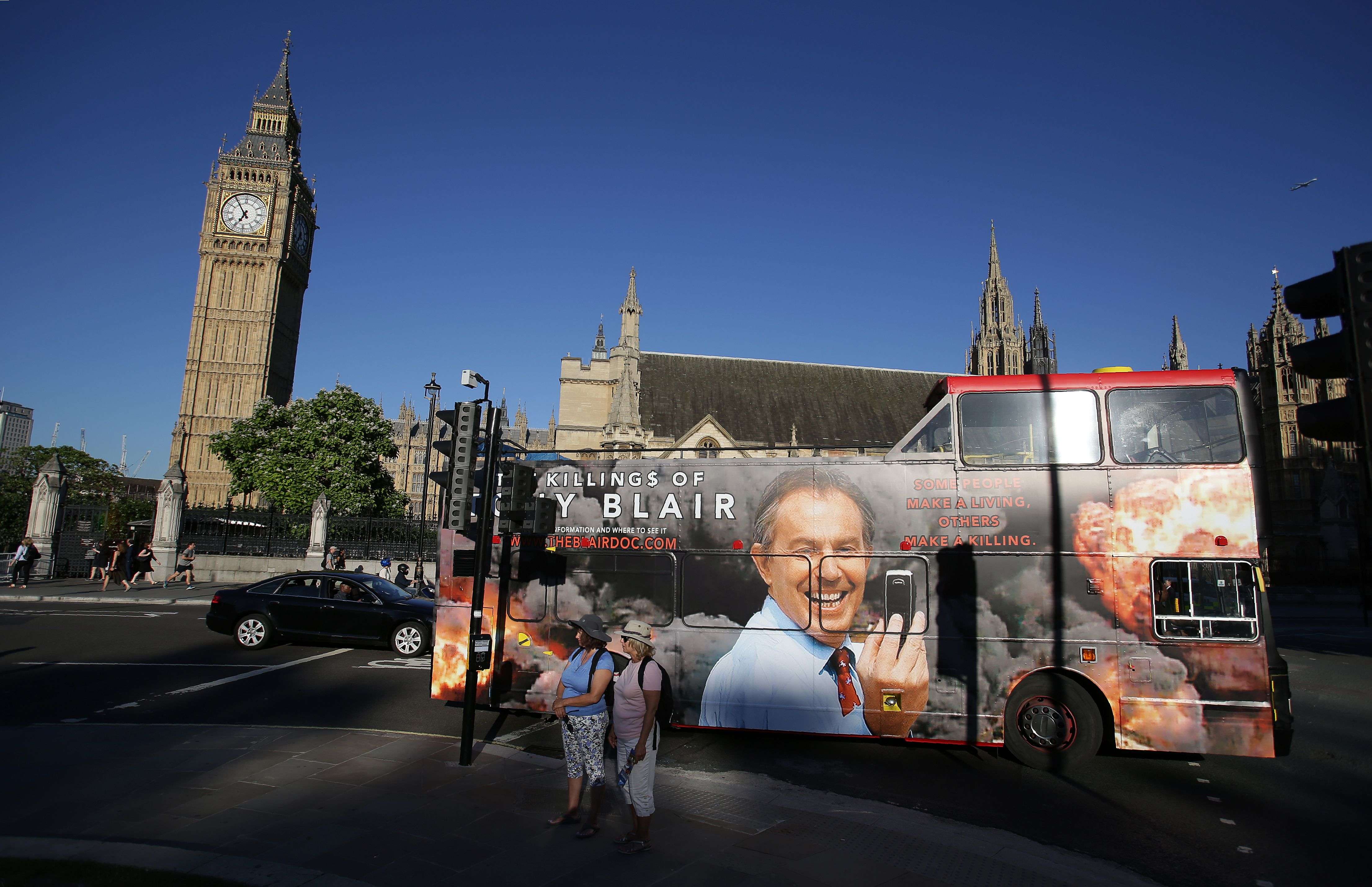 A bus with an advertisement for a film about Tony Blair passes the Houses of Parliament in London. Photo: AFP