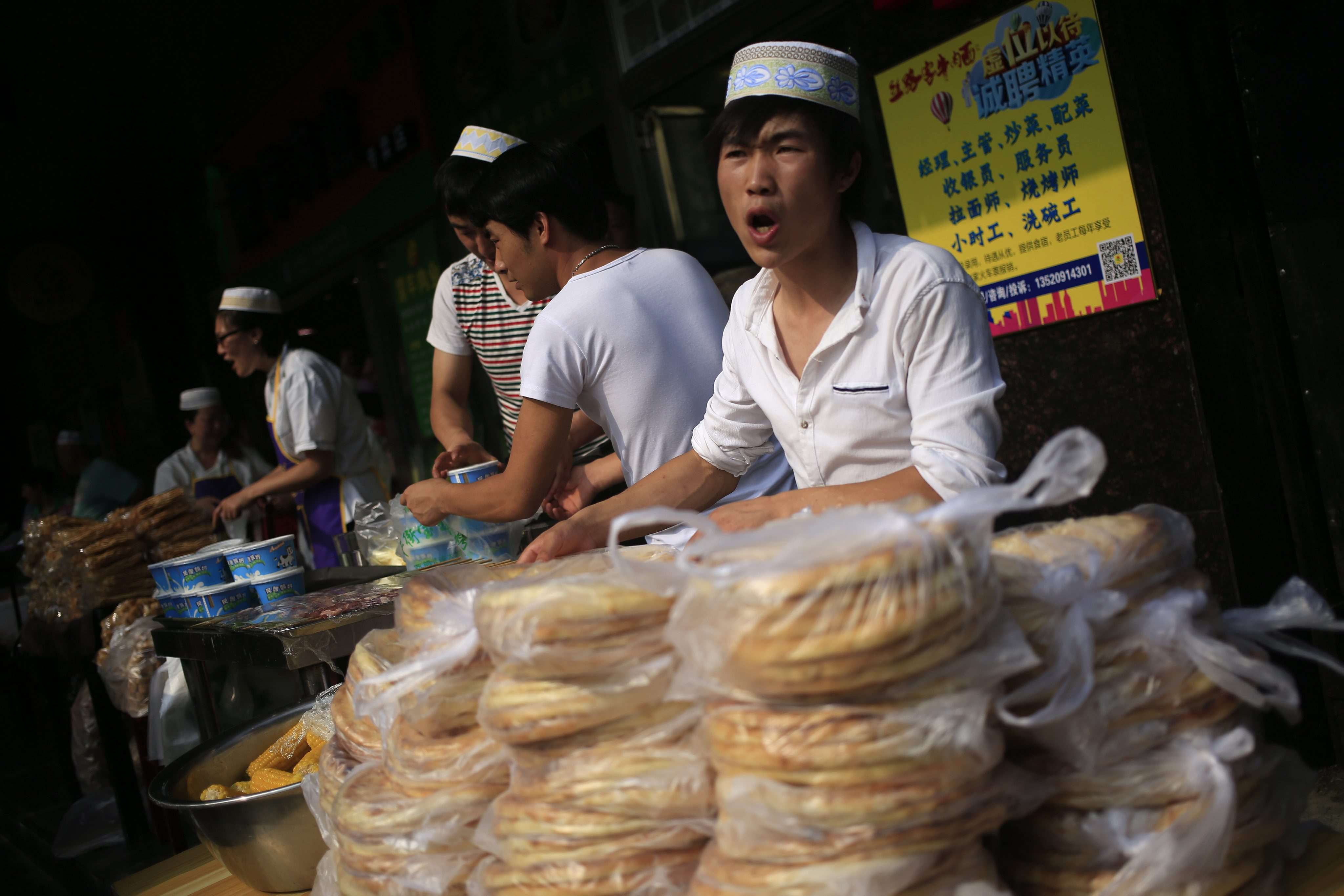 Muslim food vendors sell their goods outside the Niujie Mosque in Beijing during celebrations for the Eid ul-Fitr festival. Photo: EPA