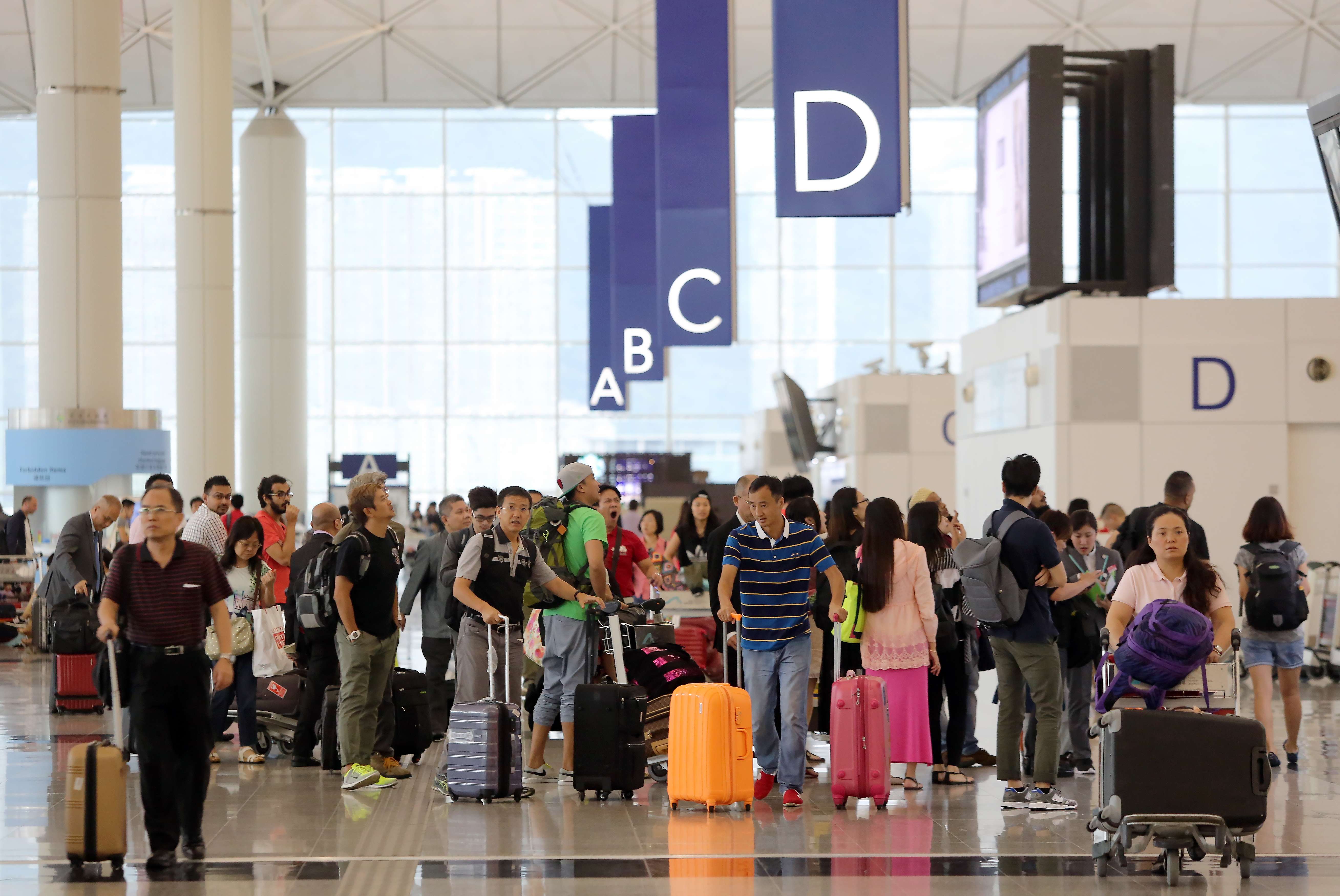 Travellers at the Hong Kong International Airport in Chek Lap Kok. Photo: SCMP Pictures