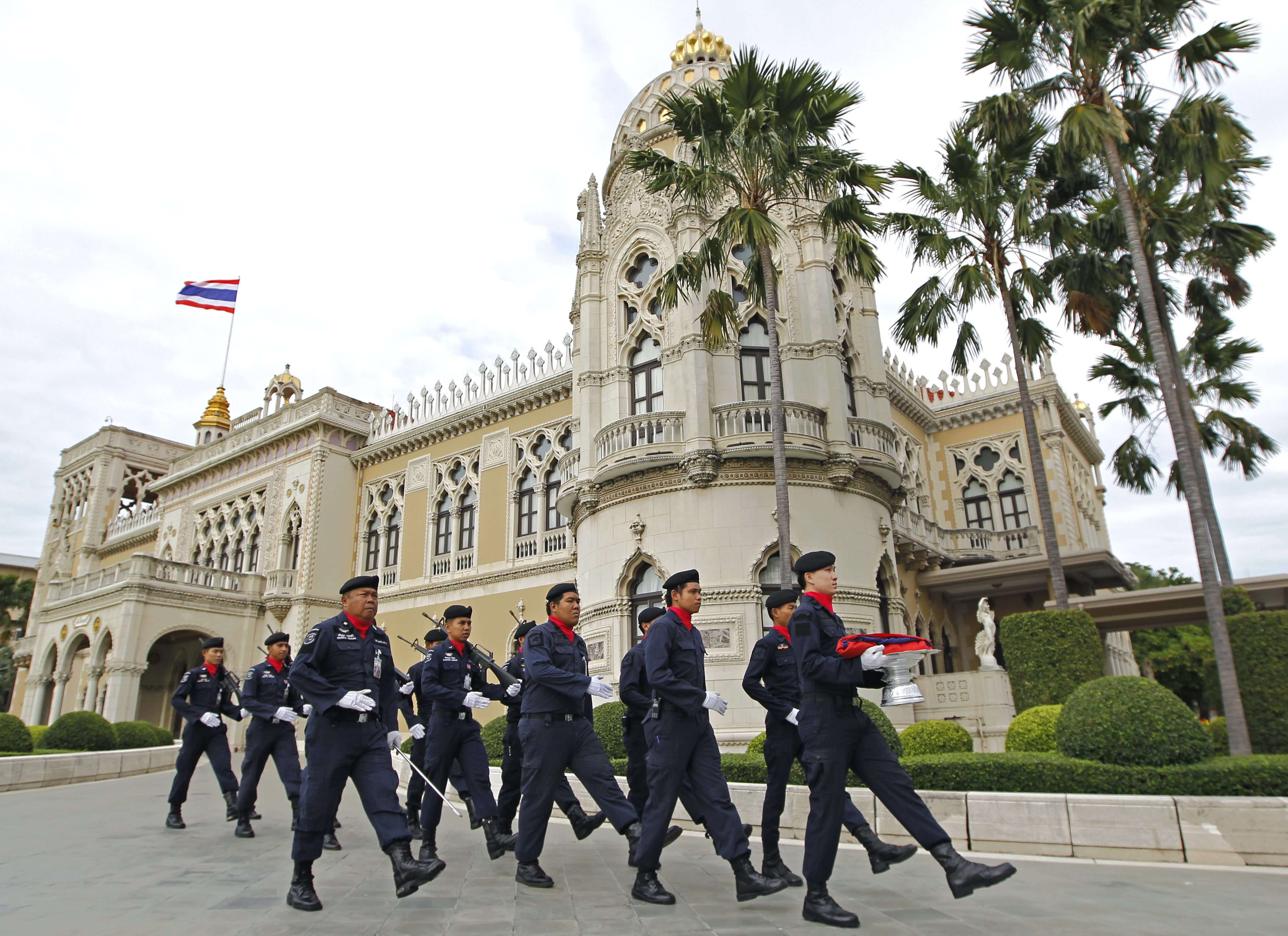 Thai police officers march in front of Government House in Bangkok. Photo: EPA
