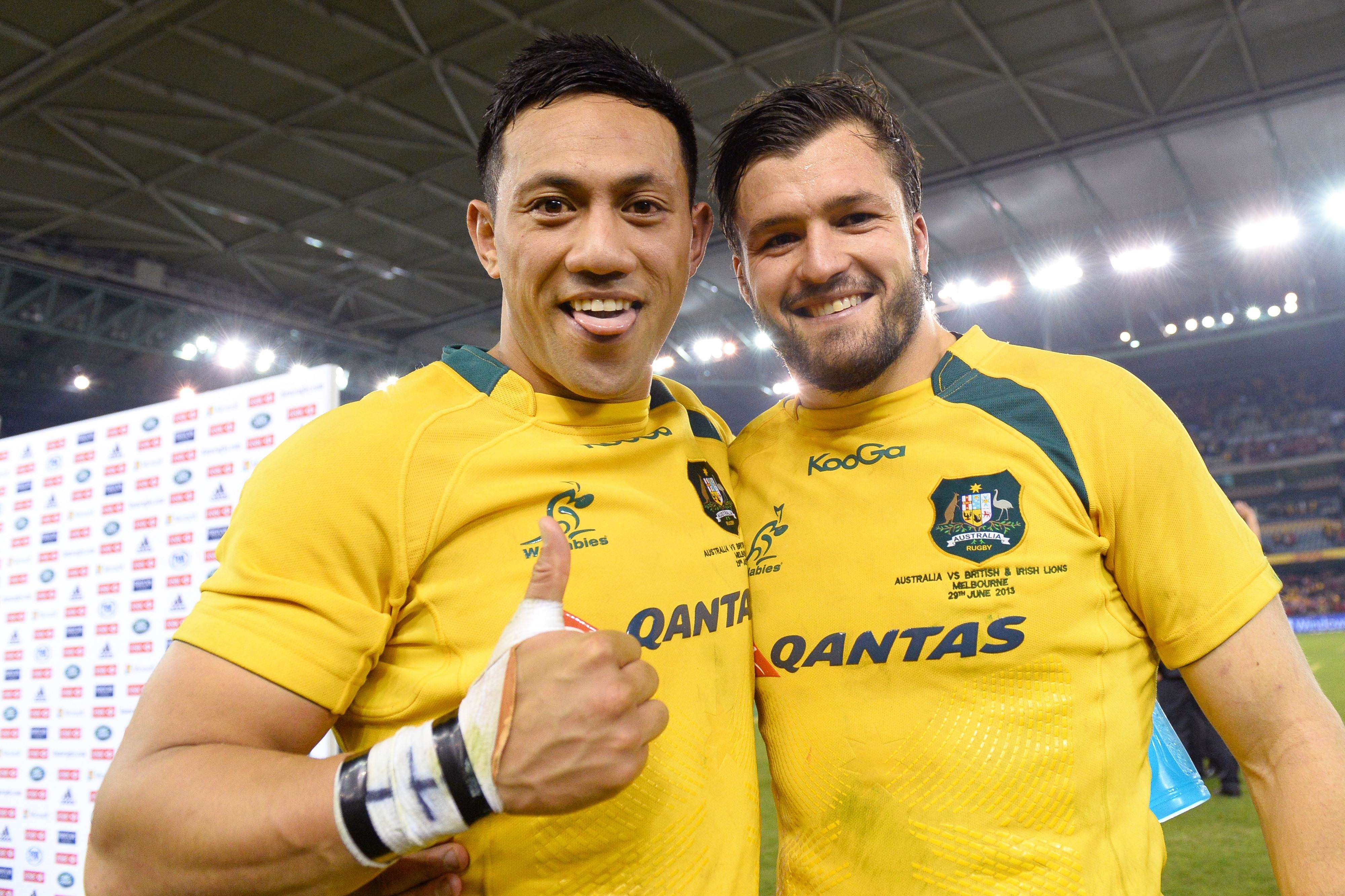 Christian Leali'iano (left) celebrates with team-mate Adam Ashley-Cooper after the Wallabies beat the British & Irish Lions in Melbourne in 2013. Photo: AFP