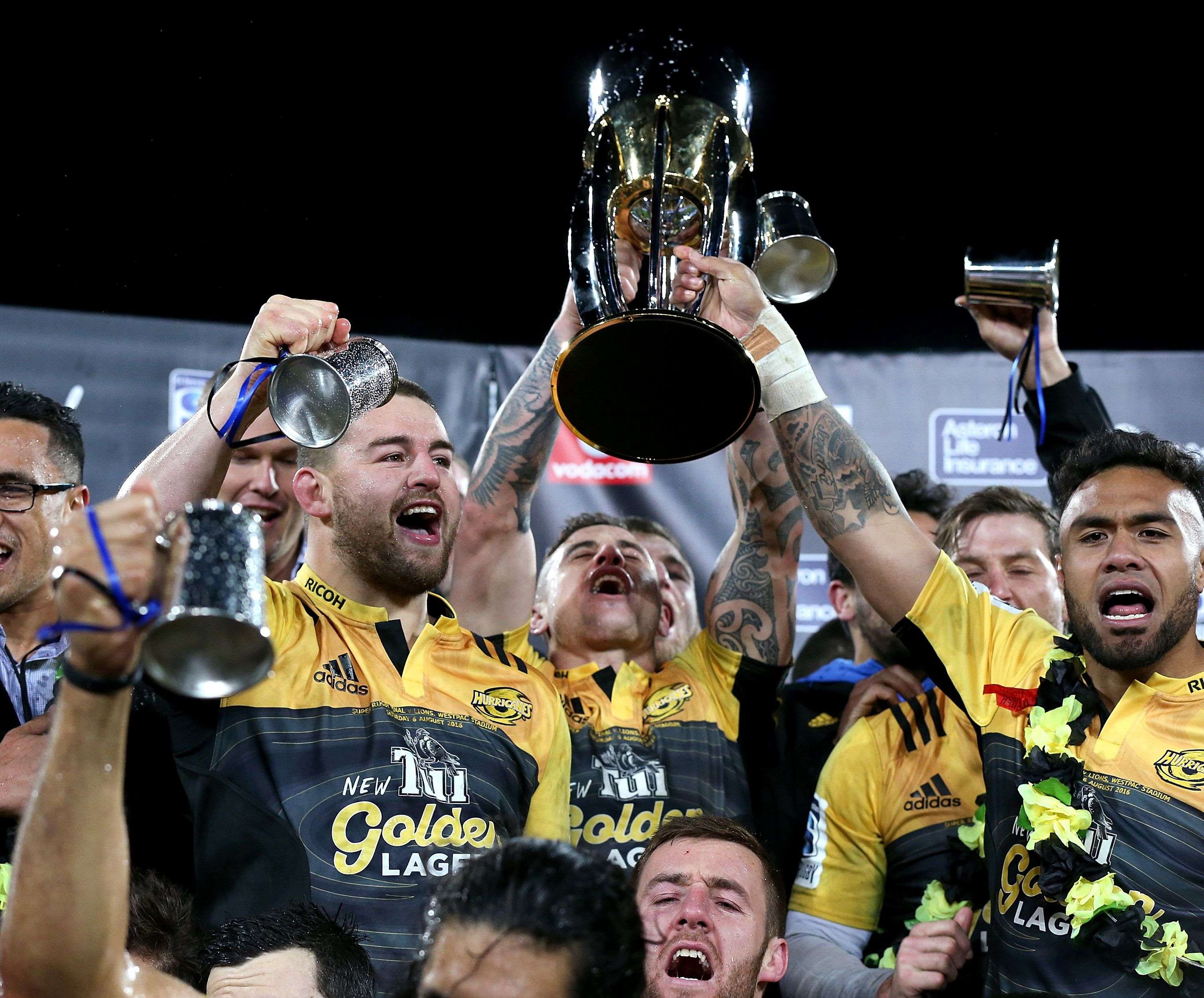 Captain Dane Coles (left) and Hurricanes teammates celebrate with the trophy after winning the Super Rugby final against the Golden Lions. Photo: AFP