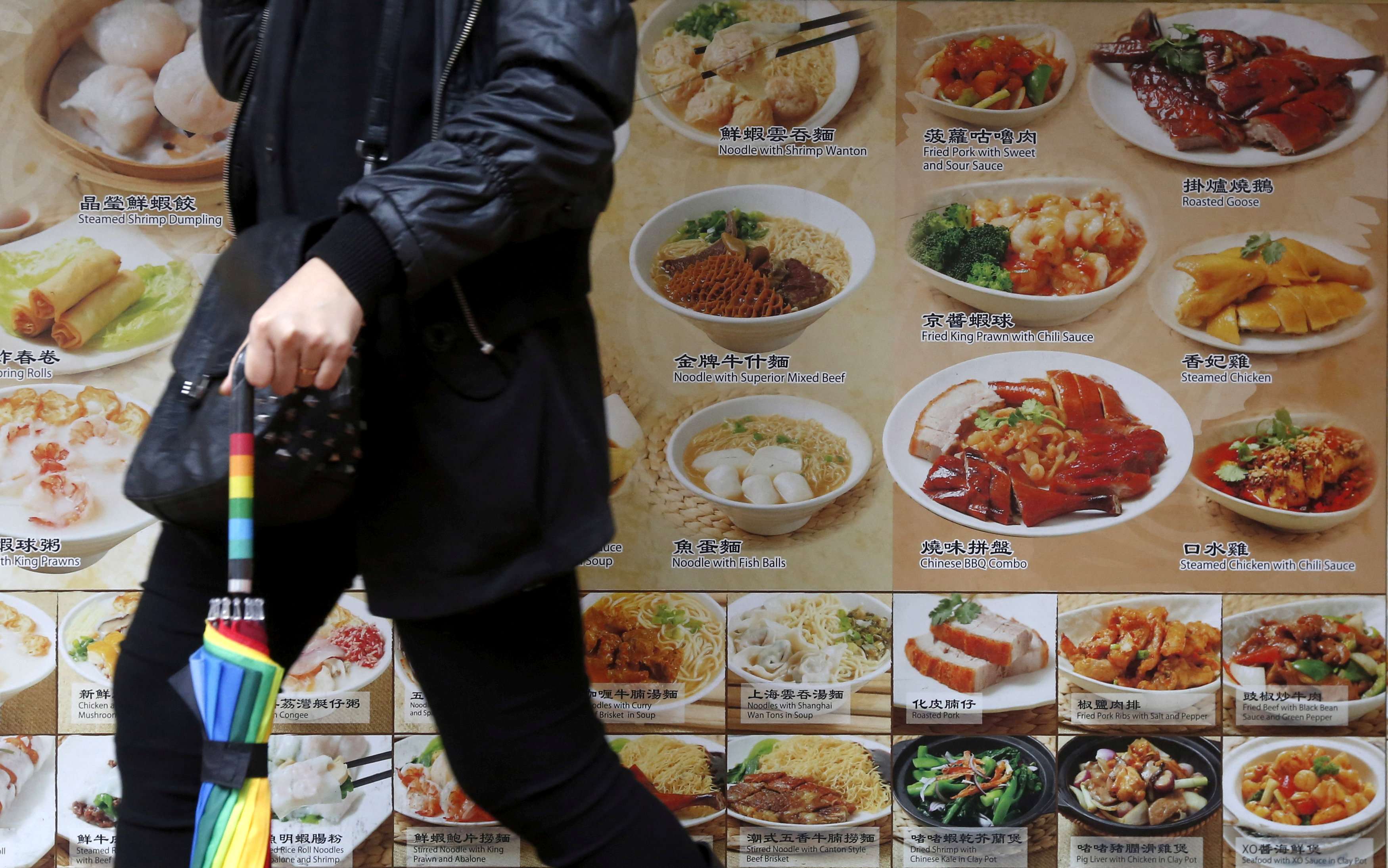 A passer-by walks outside a restaurant in Hong Kong. Photo: Reuters