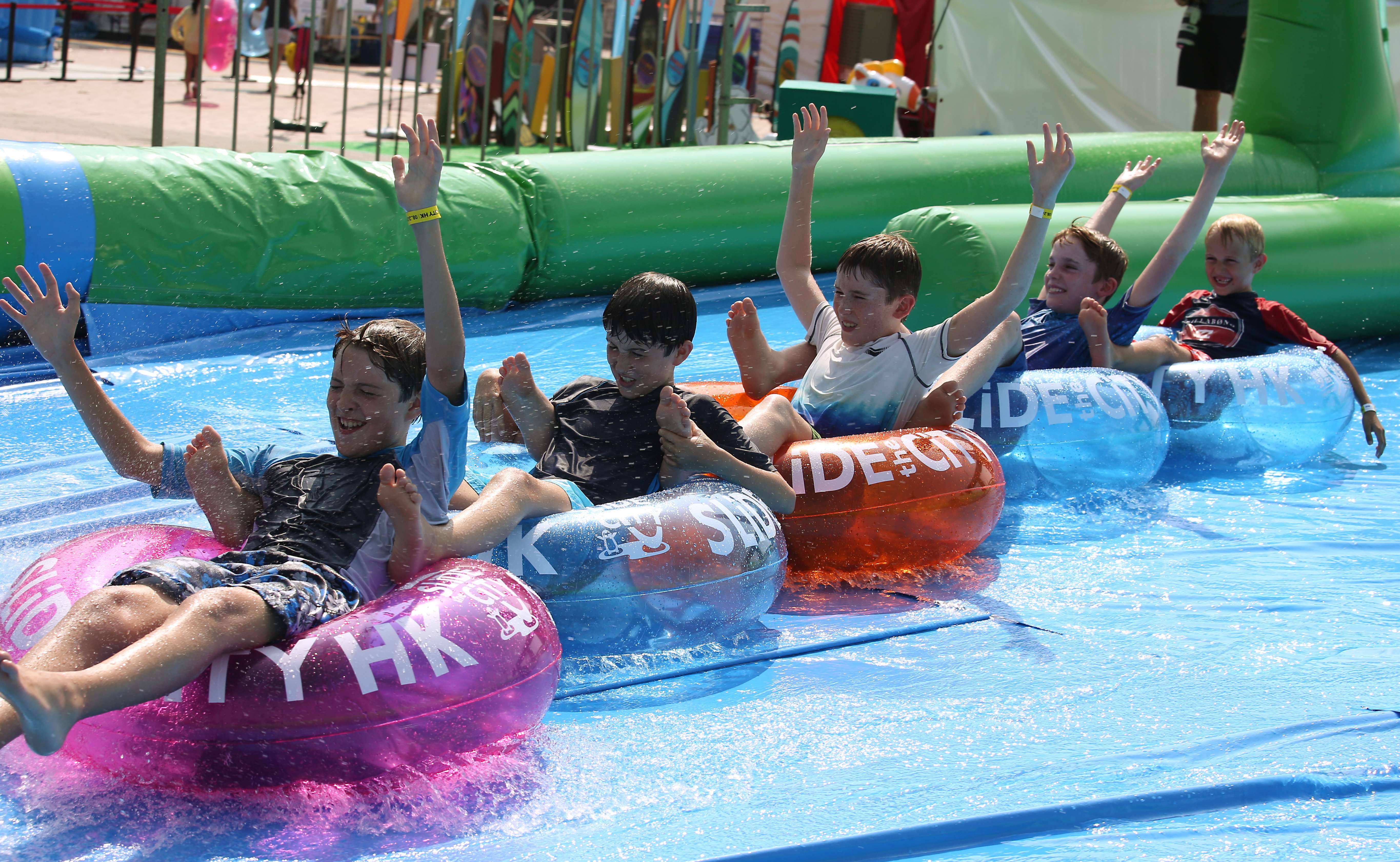 Youngsters beat the heat on the 10-metre slide. Photo: Nora Tam