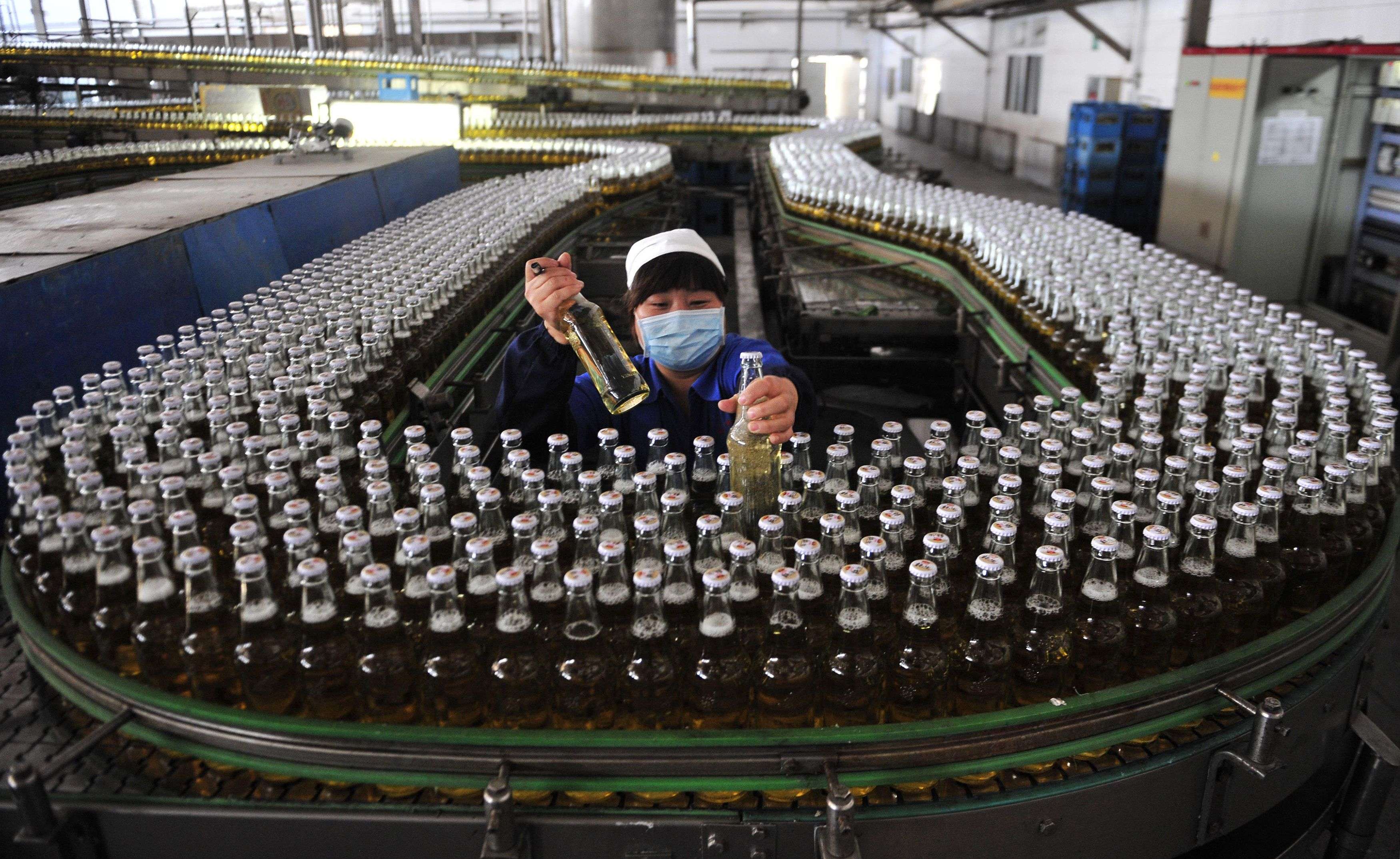 A beer assembly line inside a brewery in Shenyang, Liaoning province. Such automation could keep factory jobs and provide more high-end jobs. But as China moves up the value chain – and no longer has an endless supply of cheap labour – India and the ASEAN member countries are expected to fill its role. Photo: Reuters
