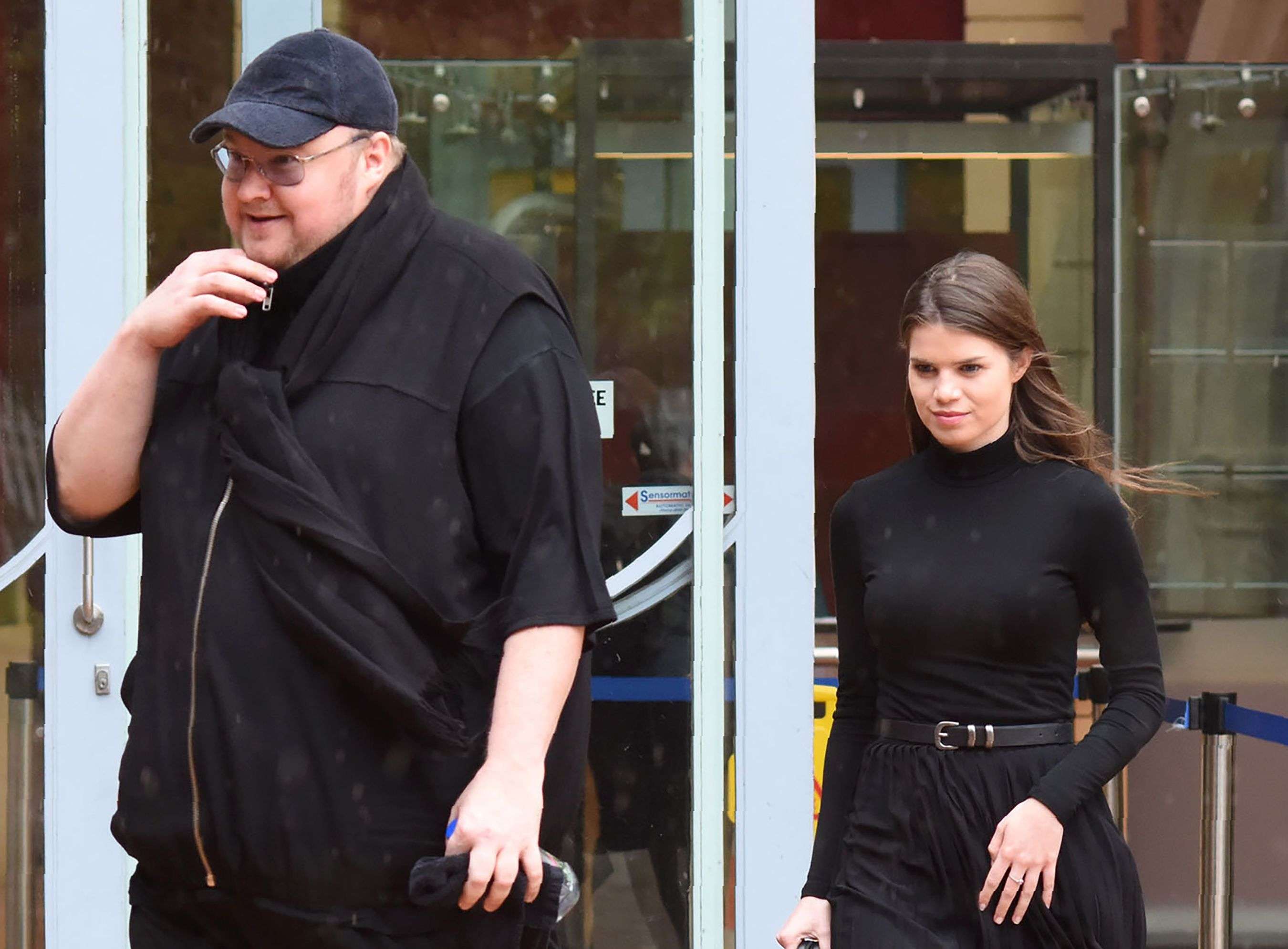 Internet mogul Kim Dotcom leaves with his girlfriend Elizabeth Donelly following his extradition appeal at the High Court in Auckland. Photo: AFP