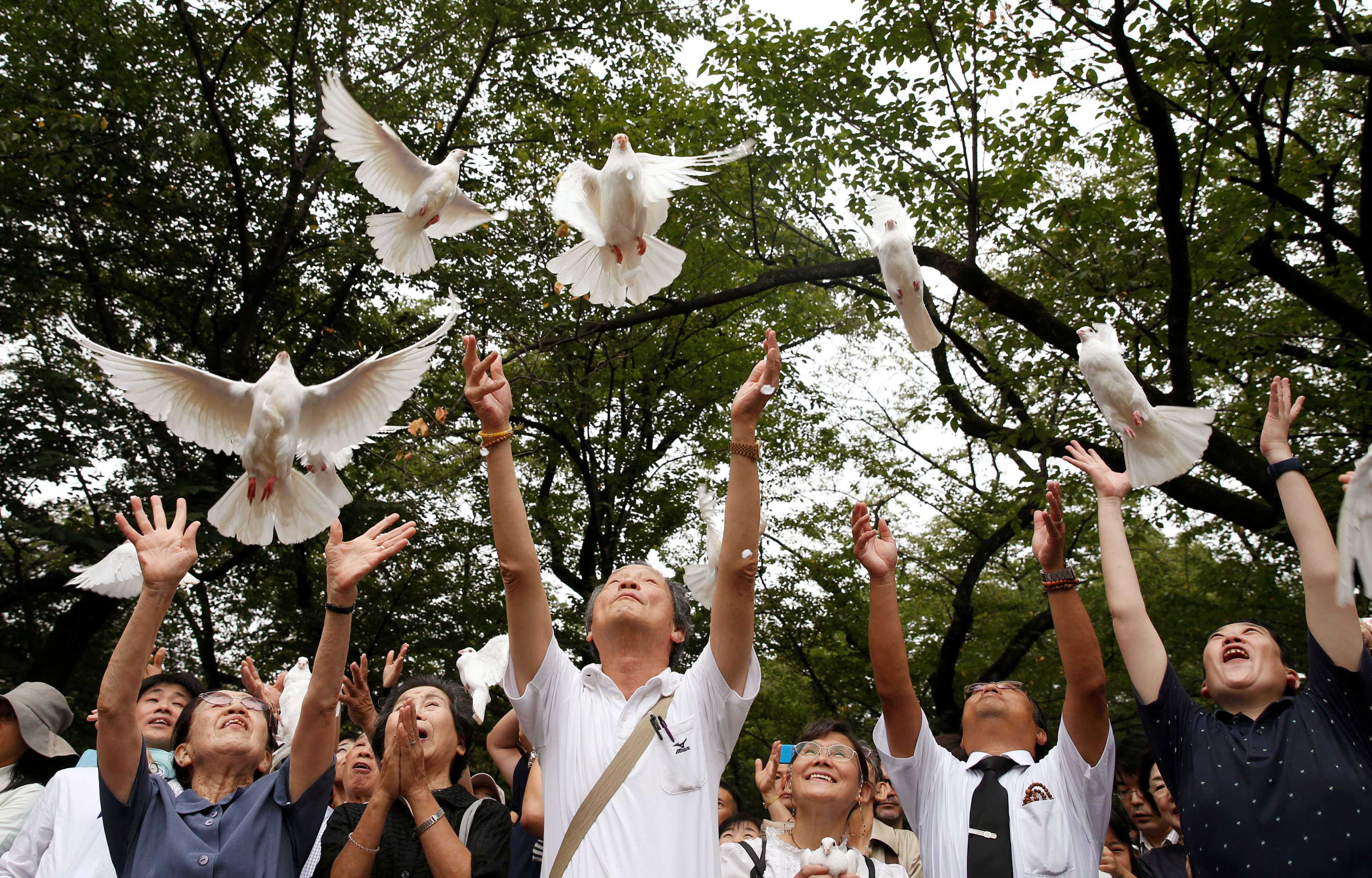 People release doves as a symbol of peace at the Yasukuni Shrine in Tokyo, in August 2016, to mark the anniversary of the end of the second world war. Photo: Reuters