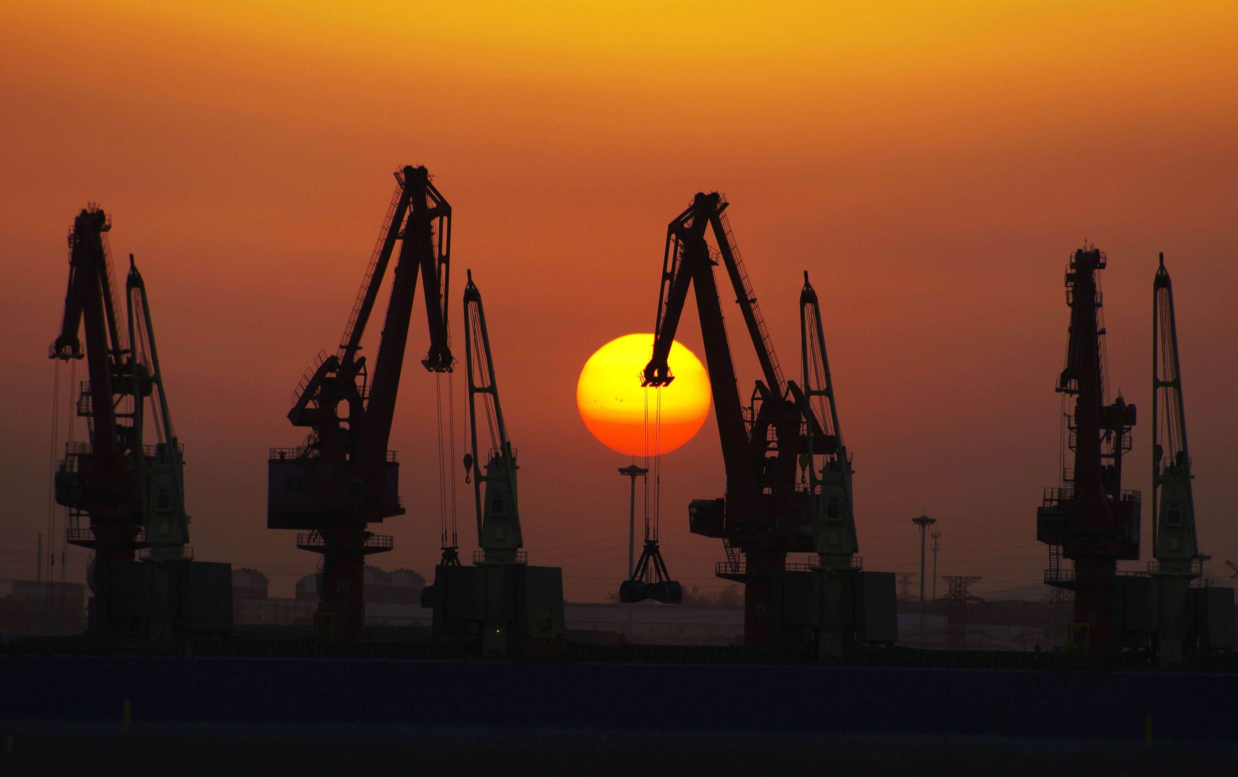 Cranes at Rizhao port in Rizhao, east China's Shandong province. The New Silk Road has to help China siphon off some of its record trade surplus. Photo: AFP