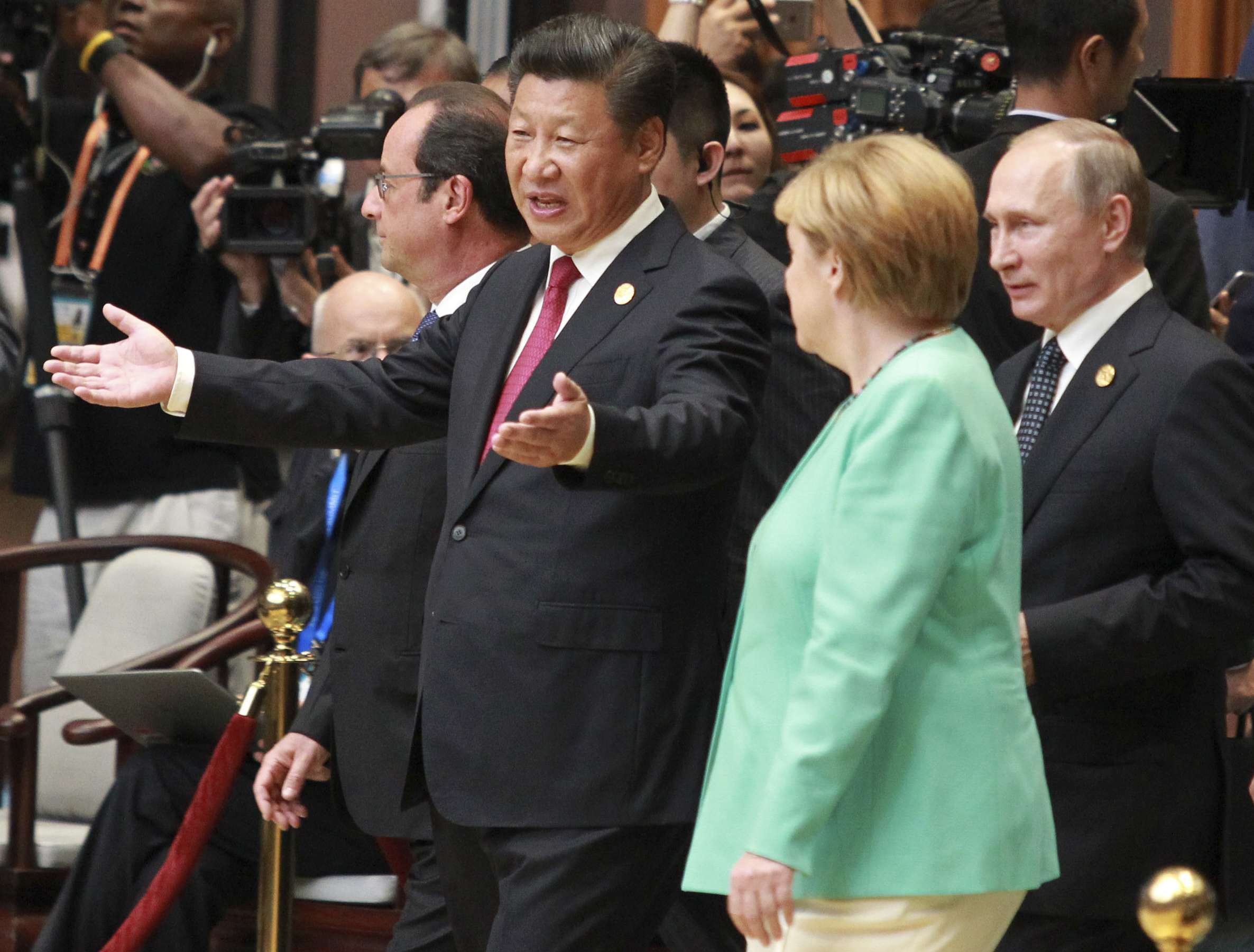 President Xi Jinping and German Chancellor Angela Merkel, French President Francois Hollande, and Russia President Vladimir Putin walk into the main G20 hall in Hangzhou on Sunday. Photo: Simon Song