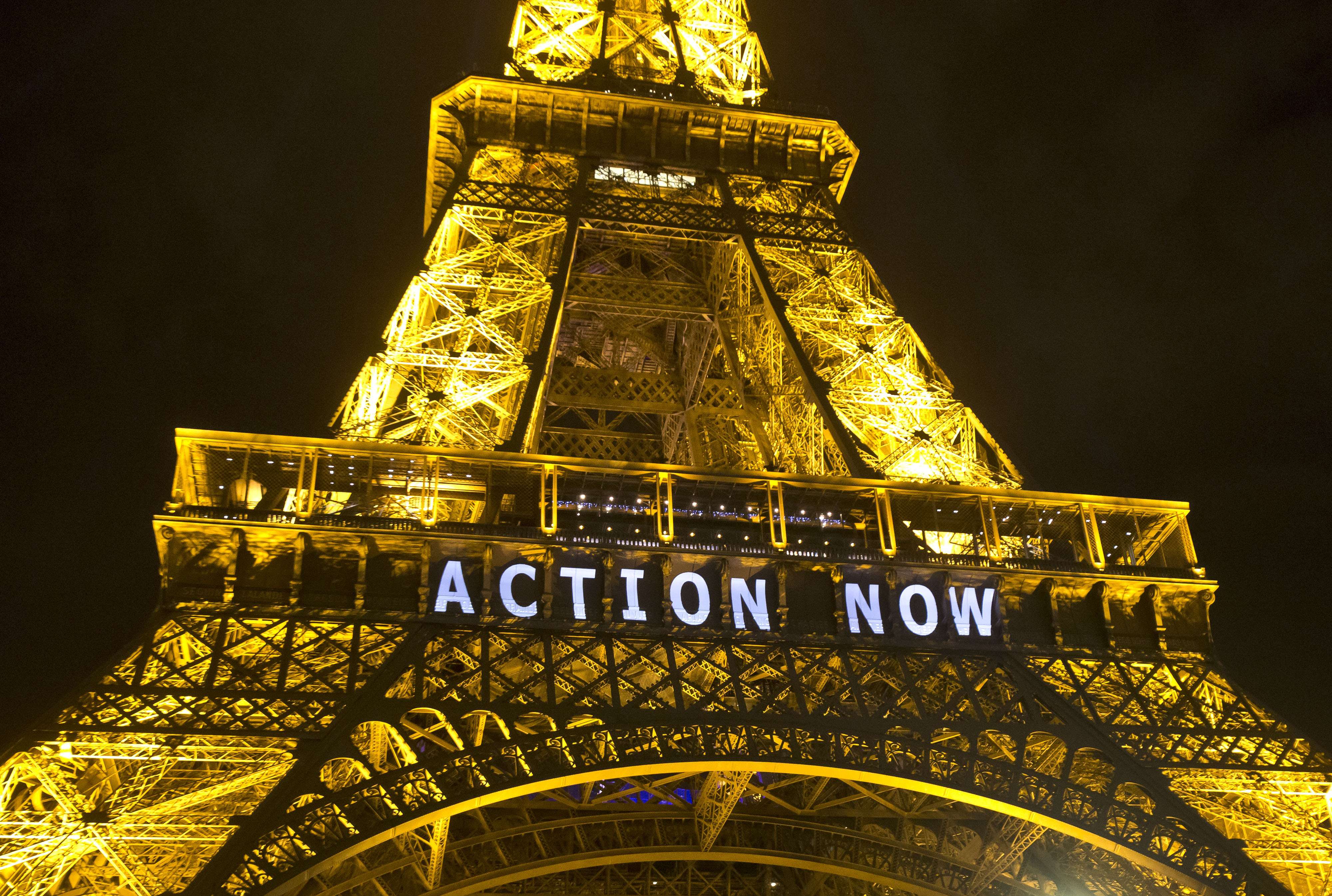 The Eiffel Tower lights up with the slogan"Action Now"before the UN Climate Change Conference in Paris in December, 2015. Photo: AP