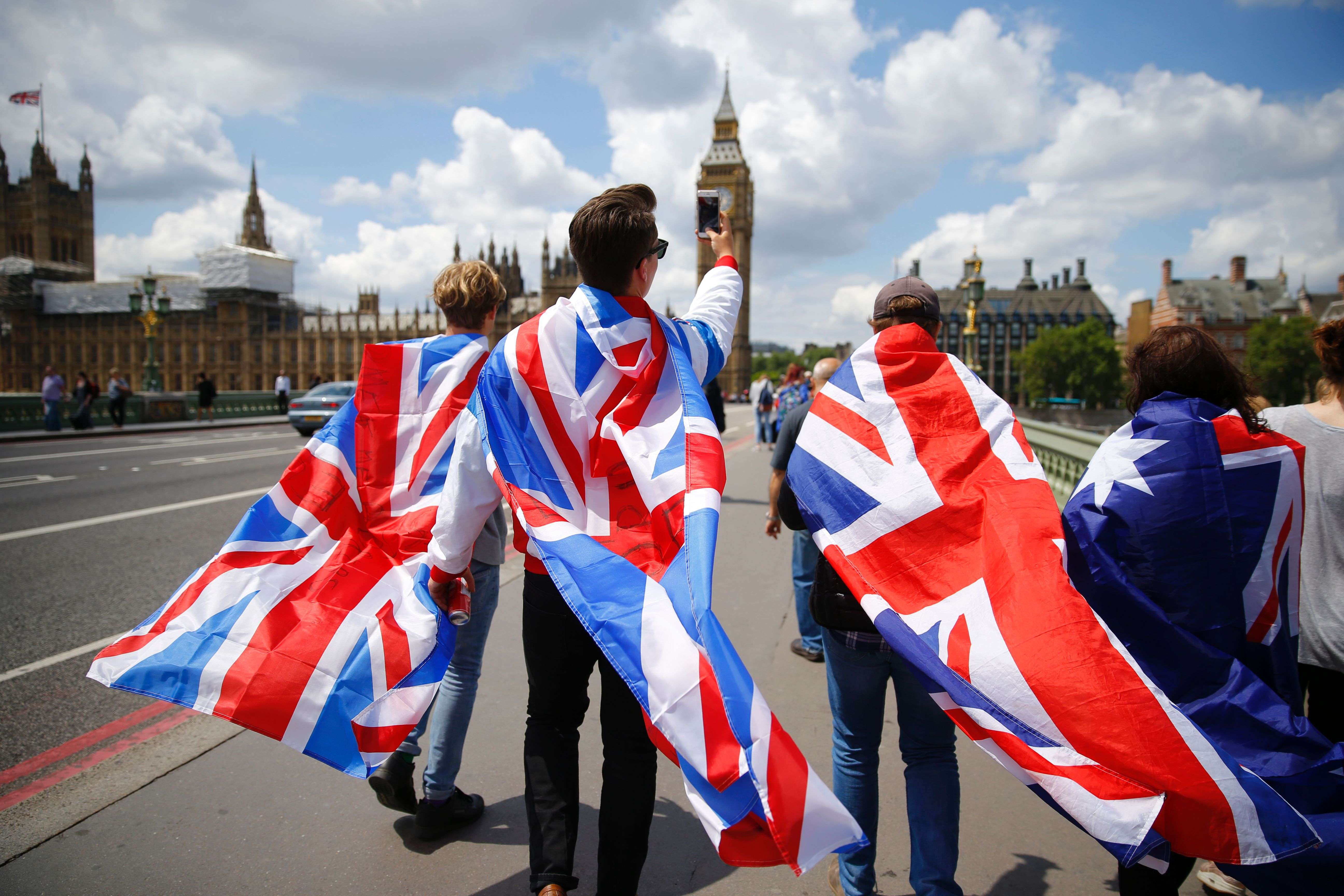 People walk over Westminster Bridge wrapped in Union flags following Britain’s Brexit vote. Photo: AFP