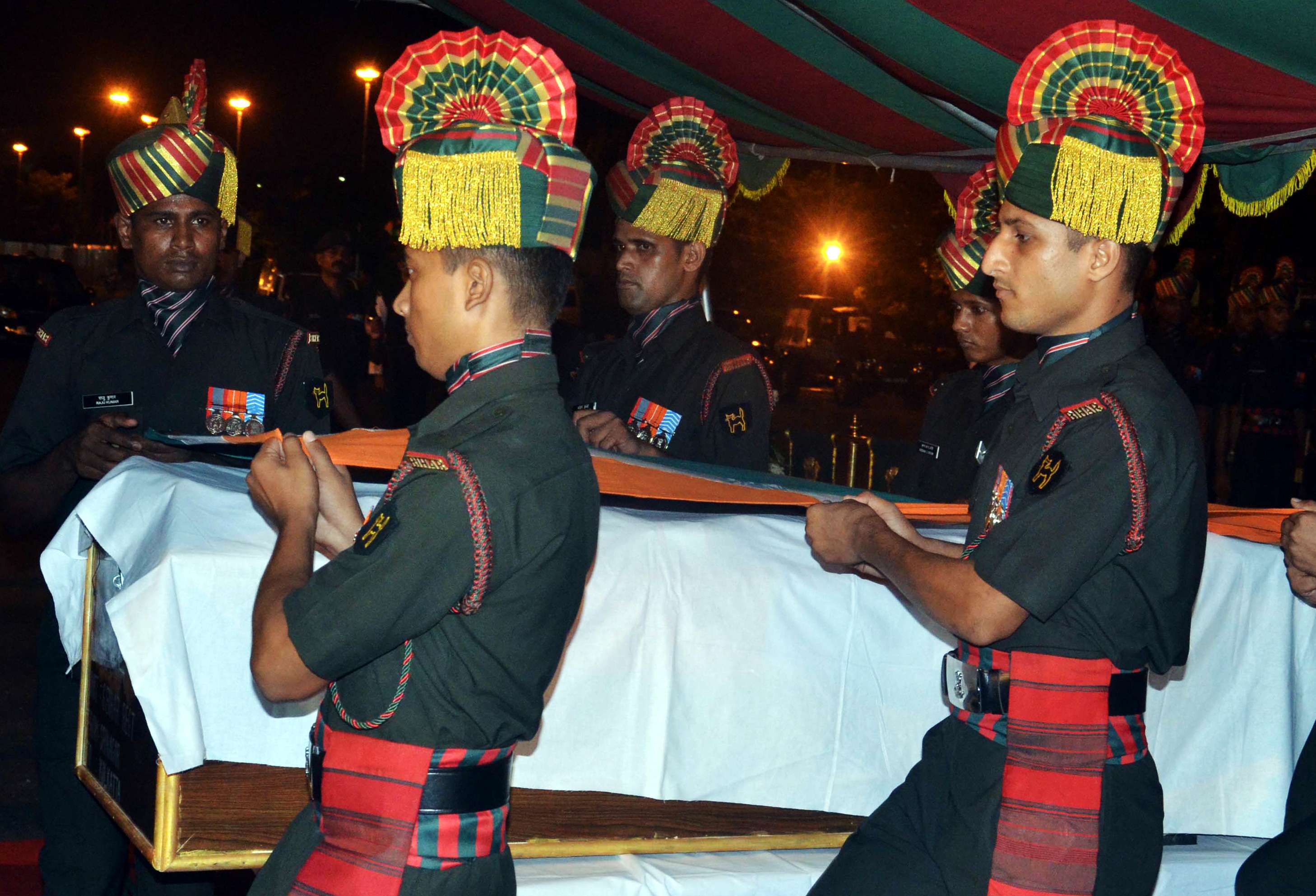 An Indian army guard of honor carries the bodies of two soldiers killed in a terrorist attack on a base in Uri. Photo: NurPhoto