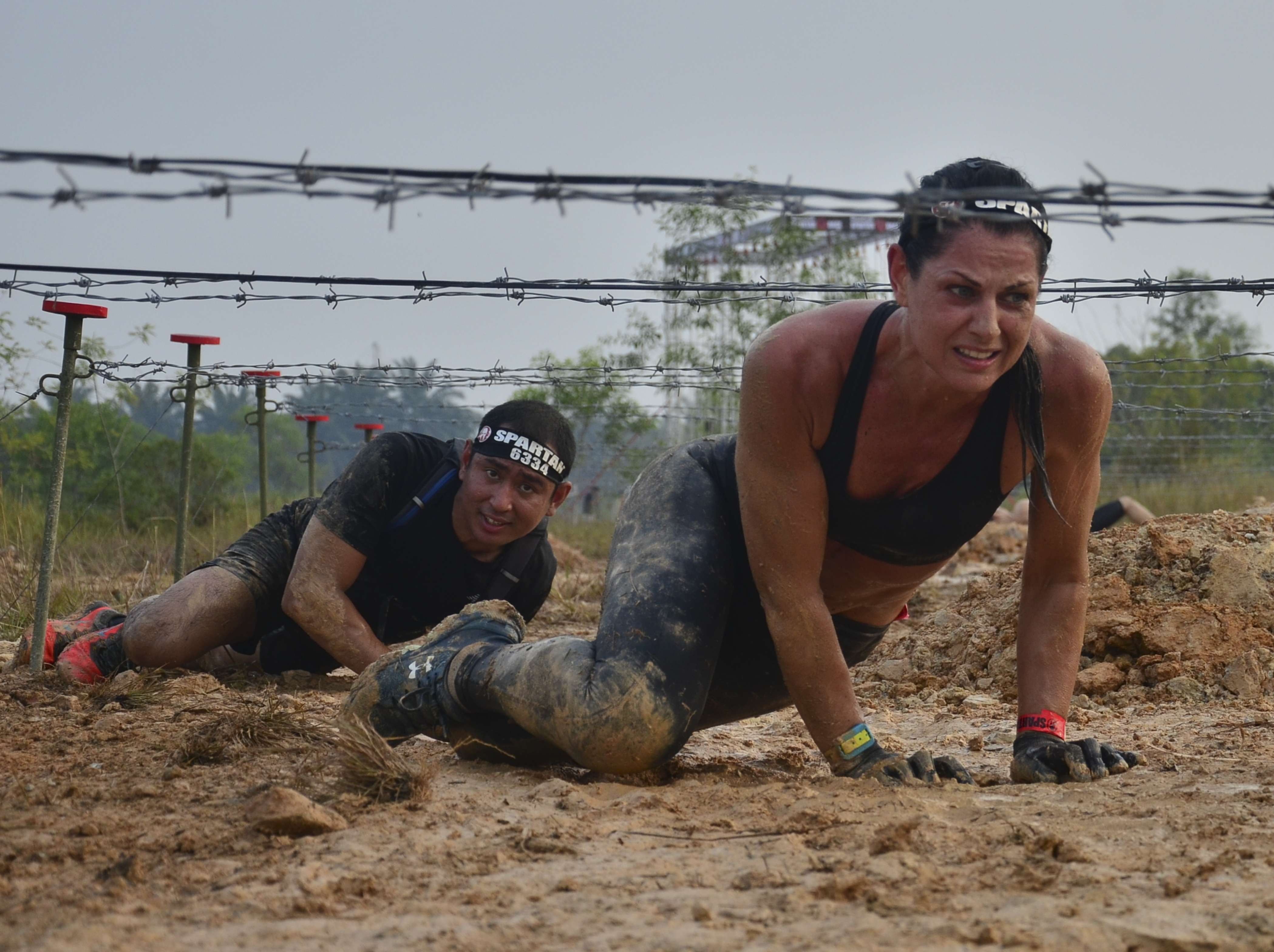 Nataile Dau, 44, crawling under barbed wire at Spartan Race Malaysia. She eventually finished third.
