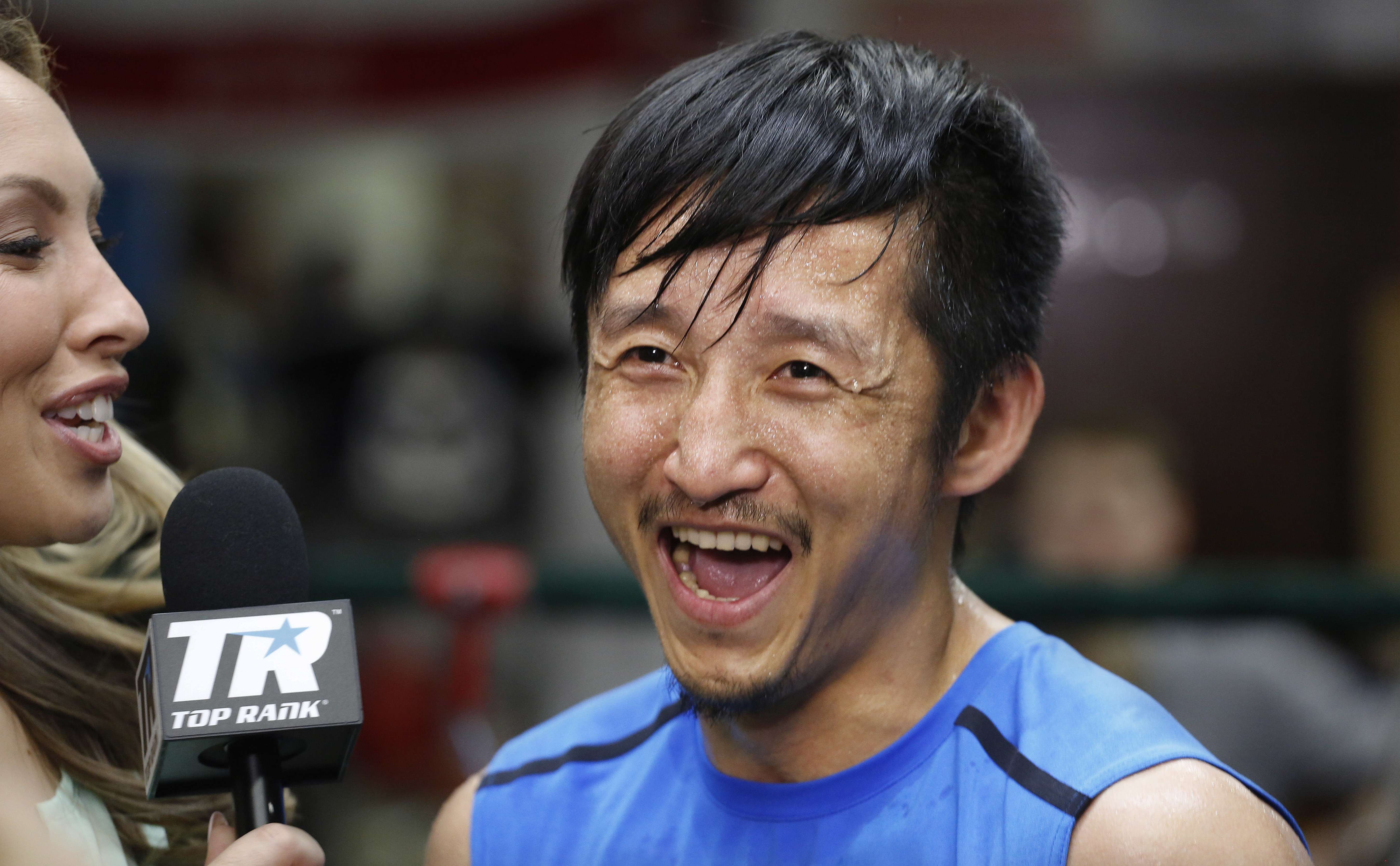 Zou Shiming smiles during a tv interview in June. (AP Photo/Mark Lennihan).