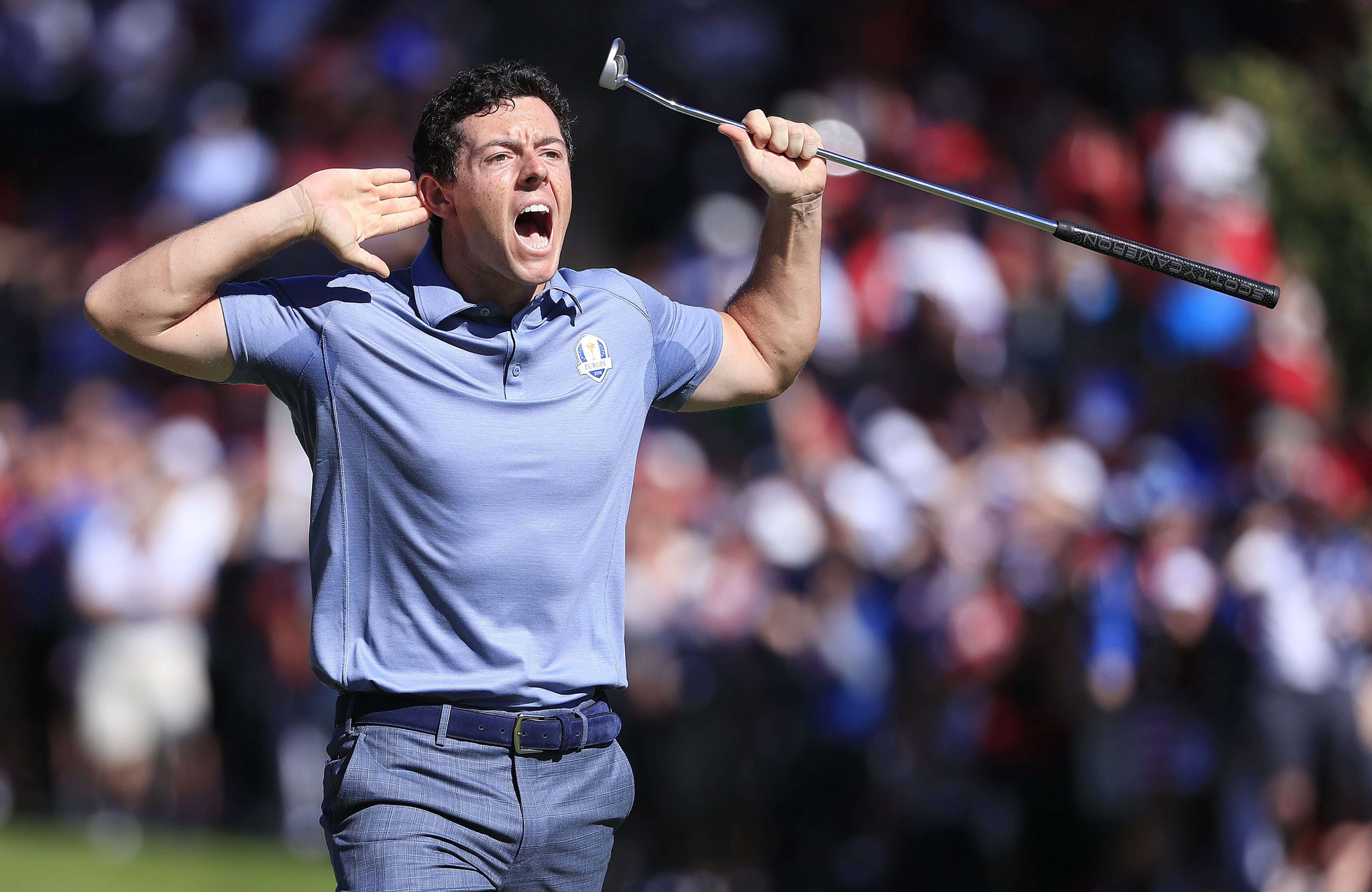 Rory McIlroy reacts to the gallery after his putt on the eighth hole during his singles match with Patrick Reed. Photo: EPA