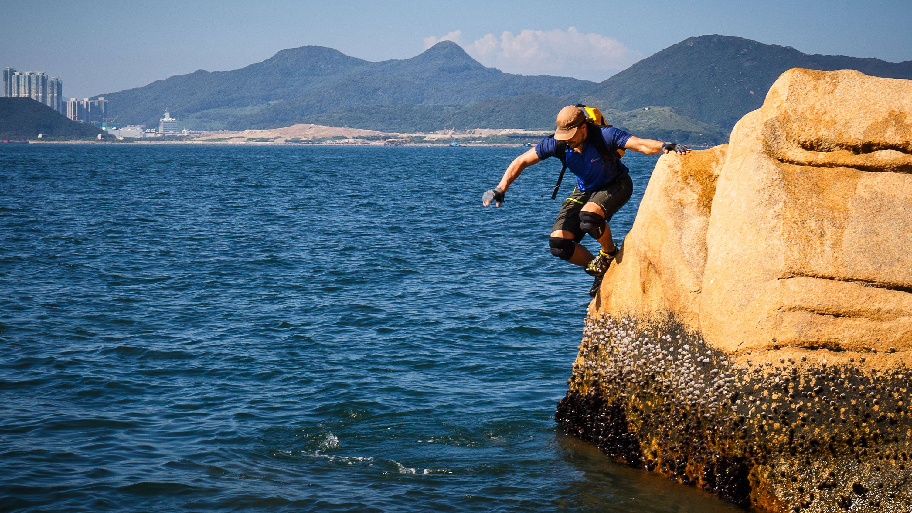Hong Kong-based climber, adventurer and motivational speaker Paul Niel jumps off a granite rock into the water on the Shek O headland while coasteering. Photo: Tessa Chan