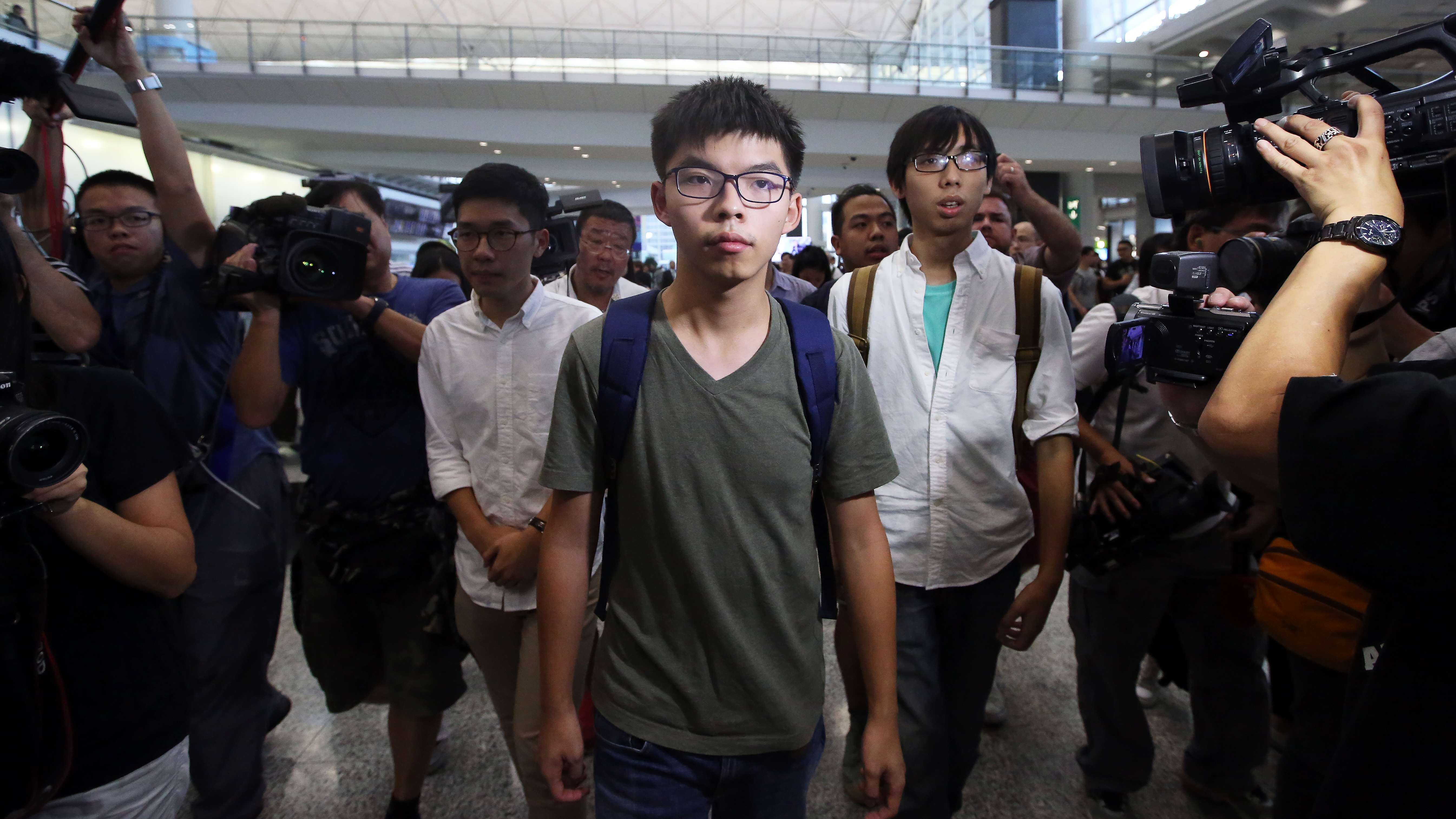 Joshua Wong (centre) arriving back at Hong Kong International Airport after being detained by Thai authorities and denied entry to Thailand. Photo: Sam Tsang