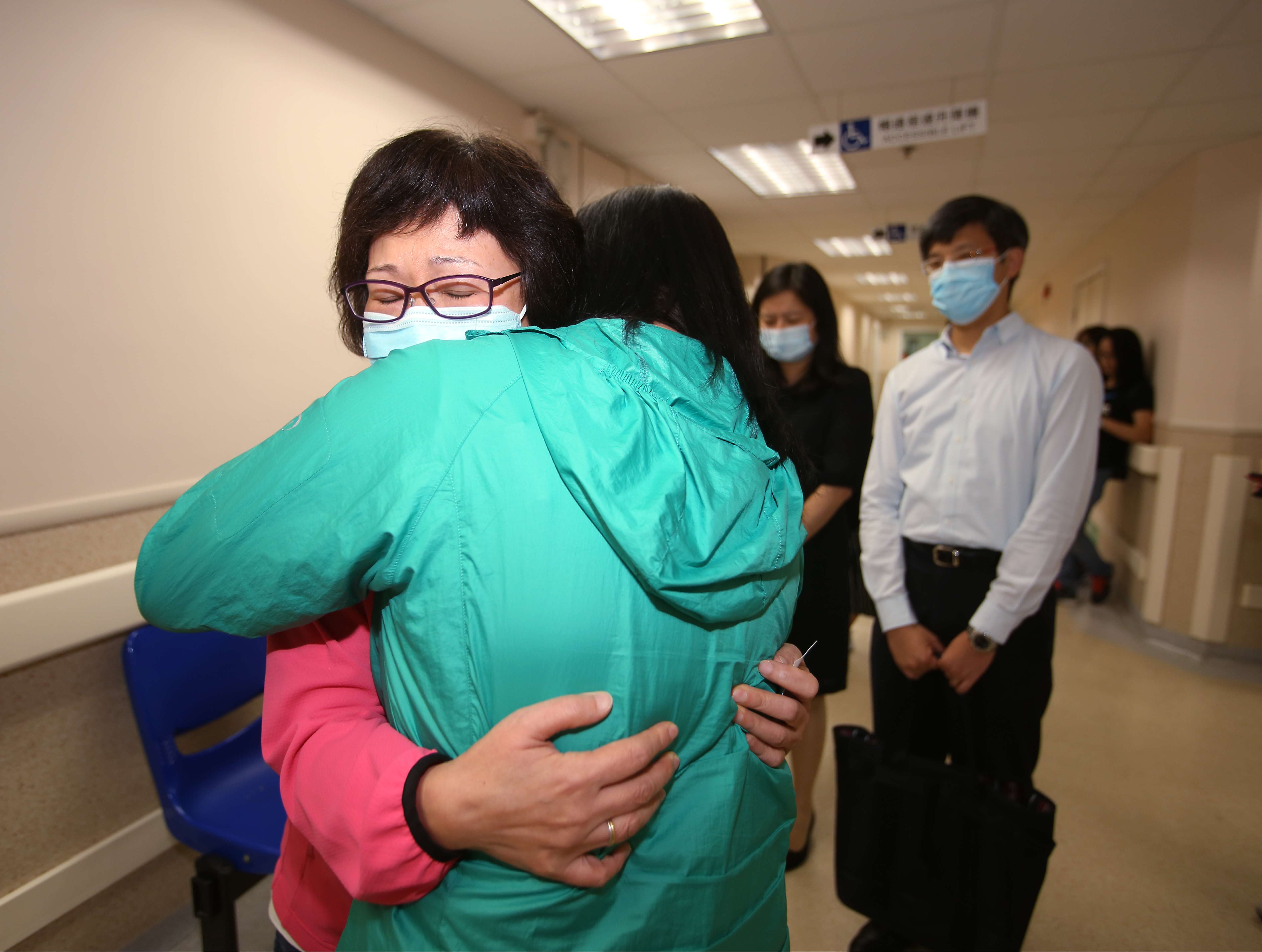 Wife Stella Chu (left) is comforted in Queen Mary Hospital on Saturday. Photo: Xiaomei Chen