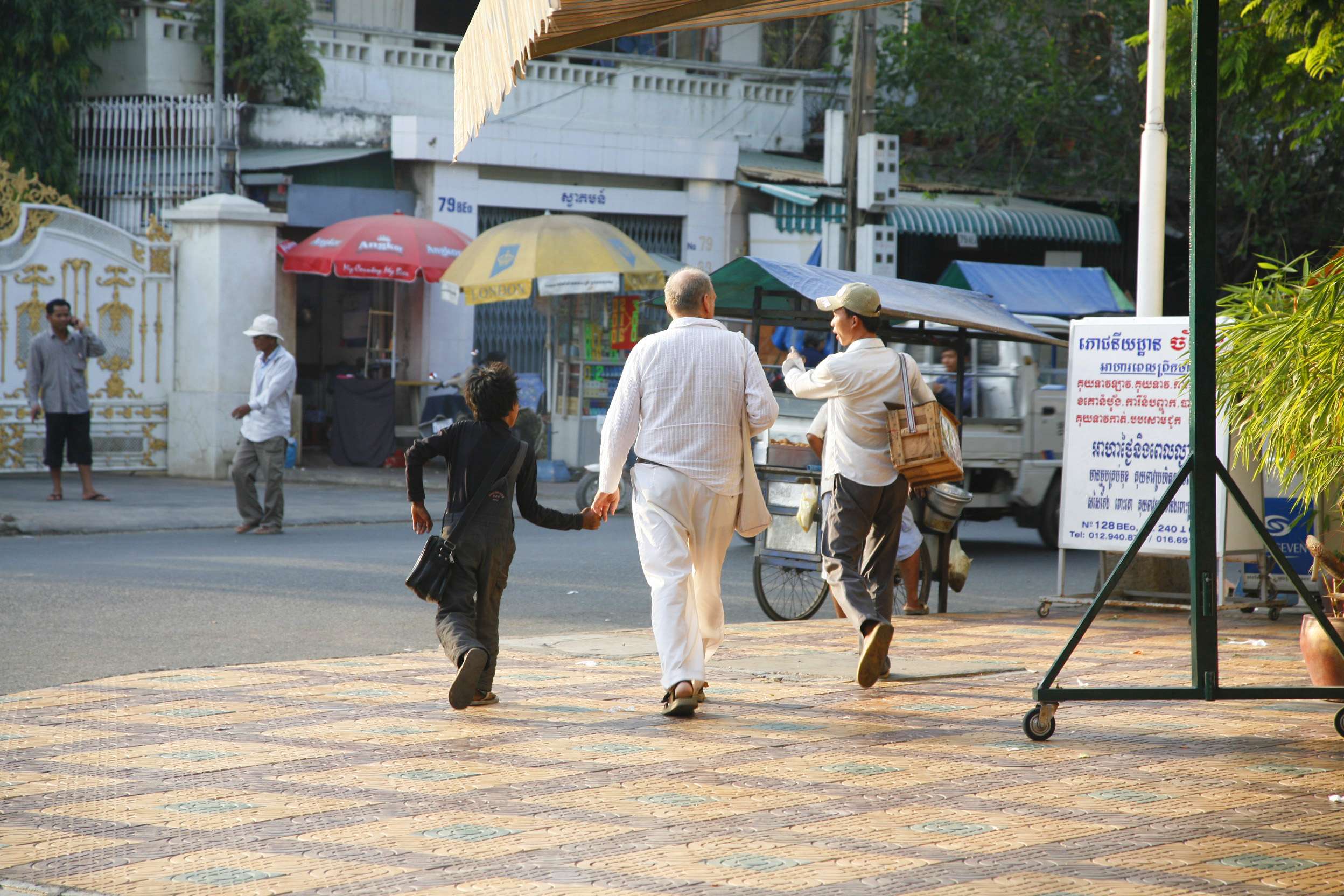A middle-aged Western man and a local boy in Phnom Penh. This kind of behaviour is usually enough to convince Action Pour Les Enfants to begin an investigation. Photo: Courtesy of APLE Cambodia
