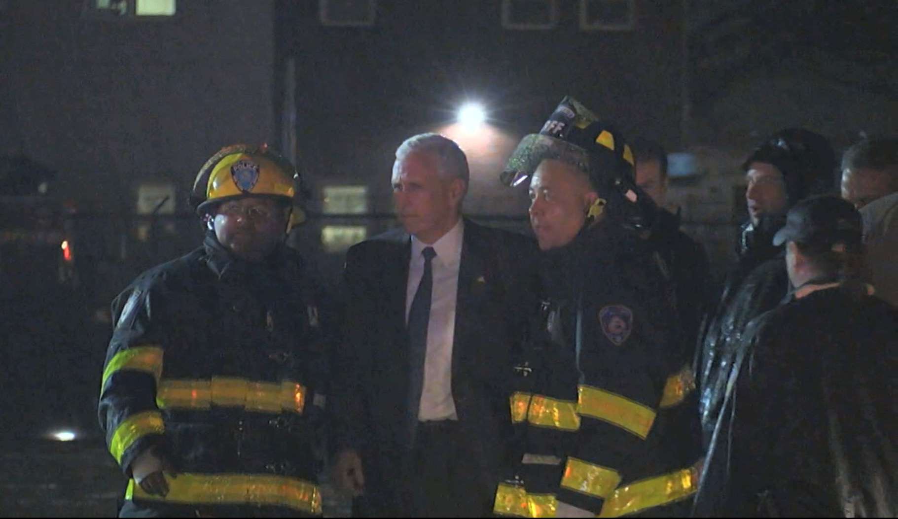 Republican presidential candidate Mike Pence with firefighters at New York's LaGuardia Airport after his campaign plane slid off the runway while landing on Thursday. Photo: AP