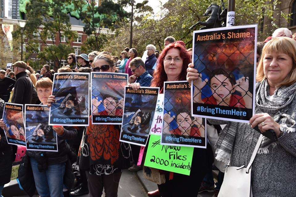 Australian demonstrators hold artworks by Abbas Alaboudi at a protest against offshore processing centres in August. Photo: Rod Hysted