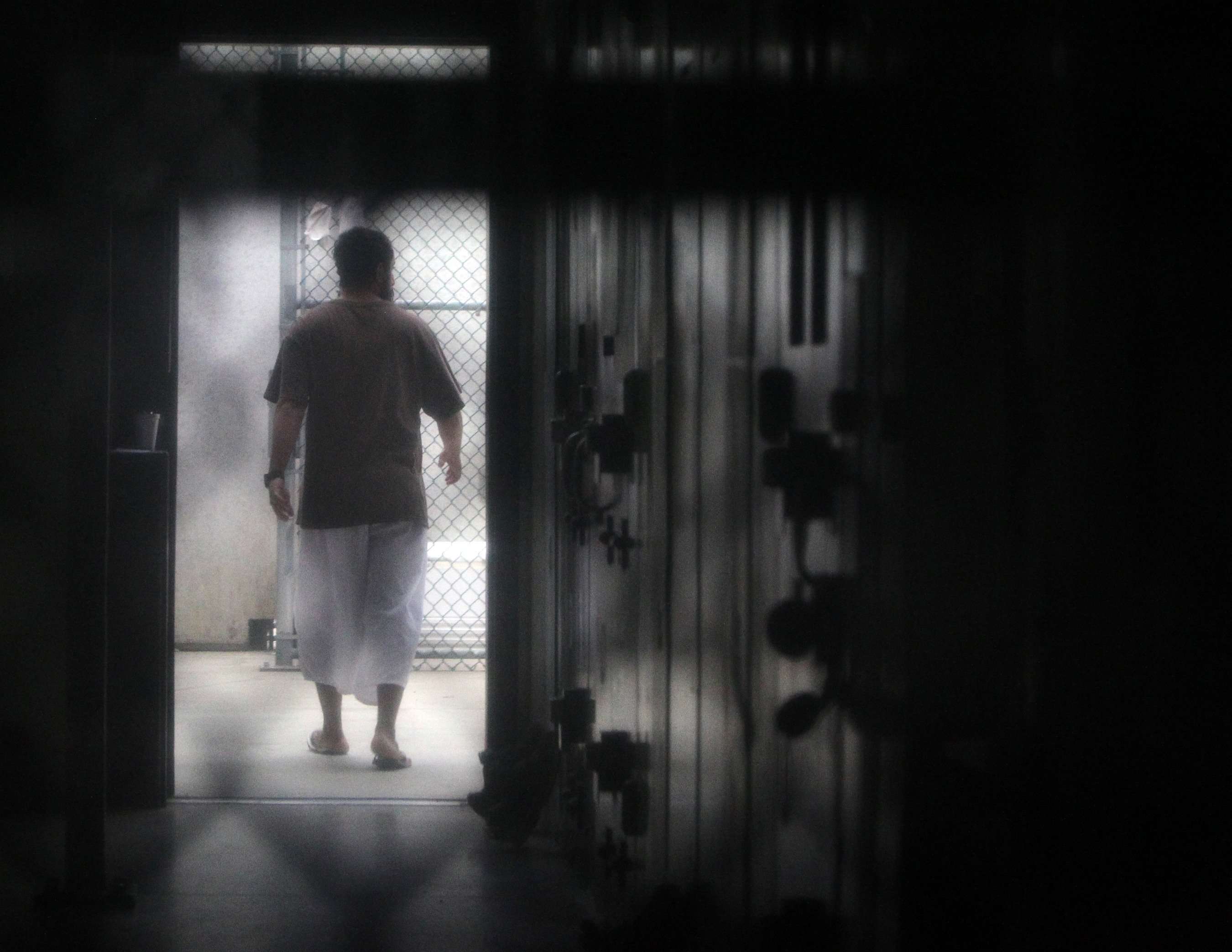 A prisoner walks around a communal cellblock in the US Navy base at Guantanamo Bay, Cuba. Photo: AFP