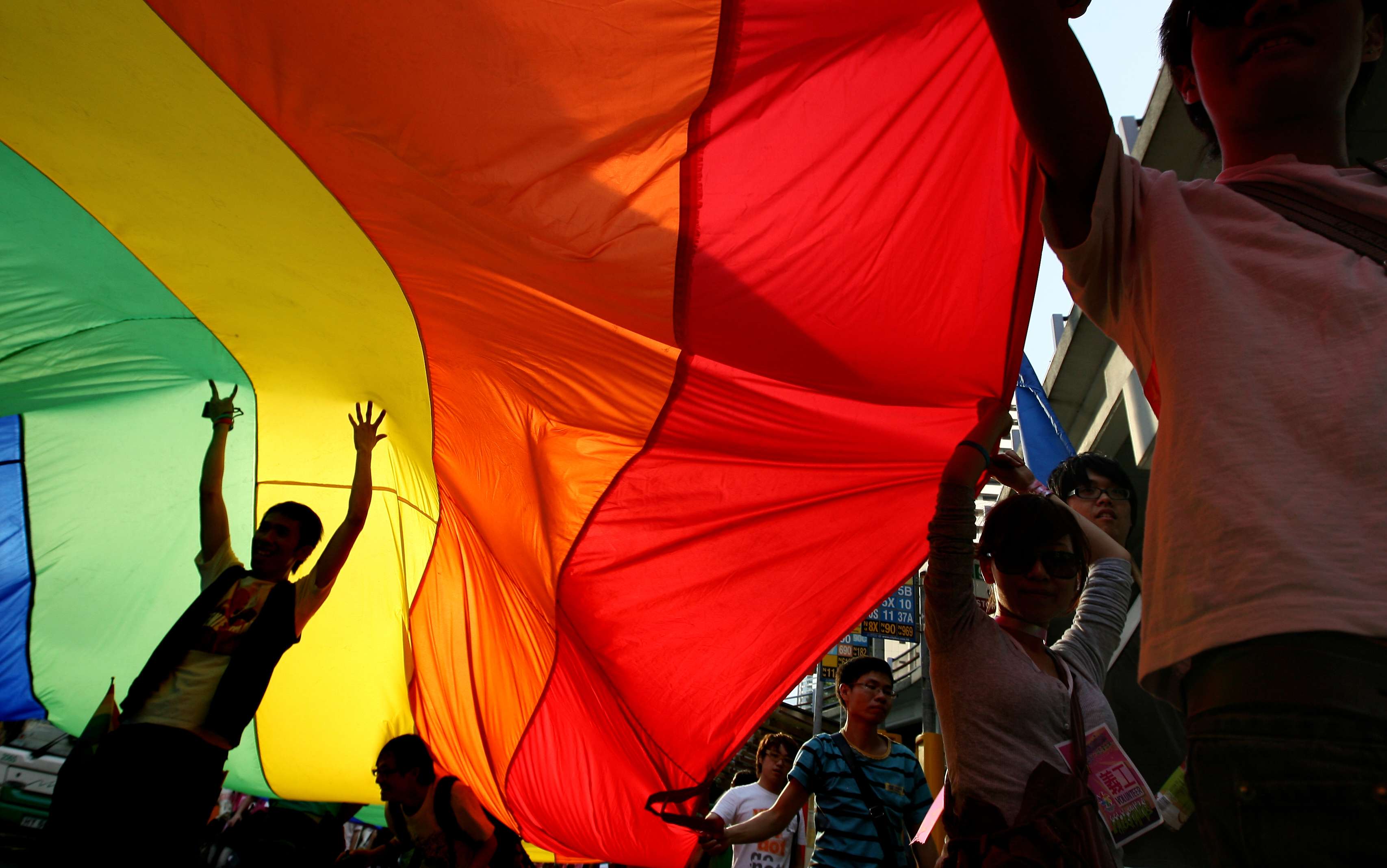 A rainbow flag held aloft at a Hong Kong Pride Parade march. Photo: Jonathan Wong