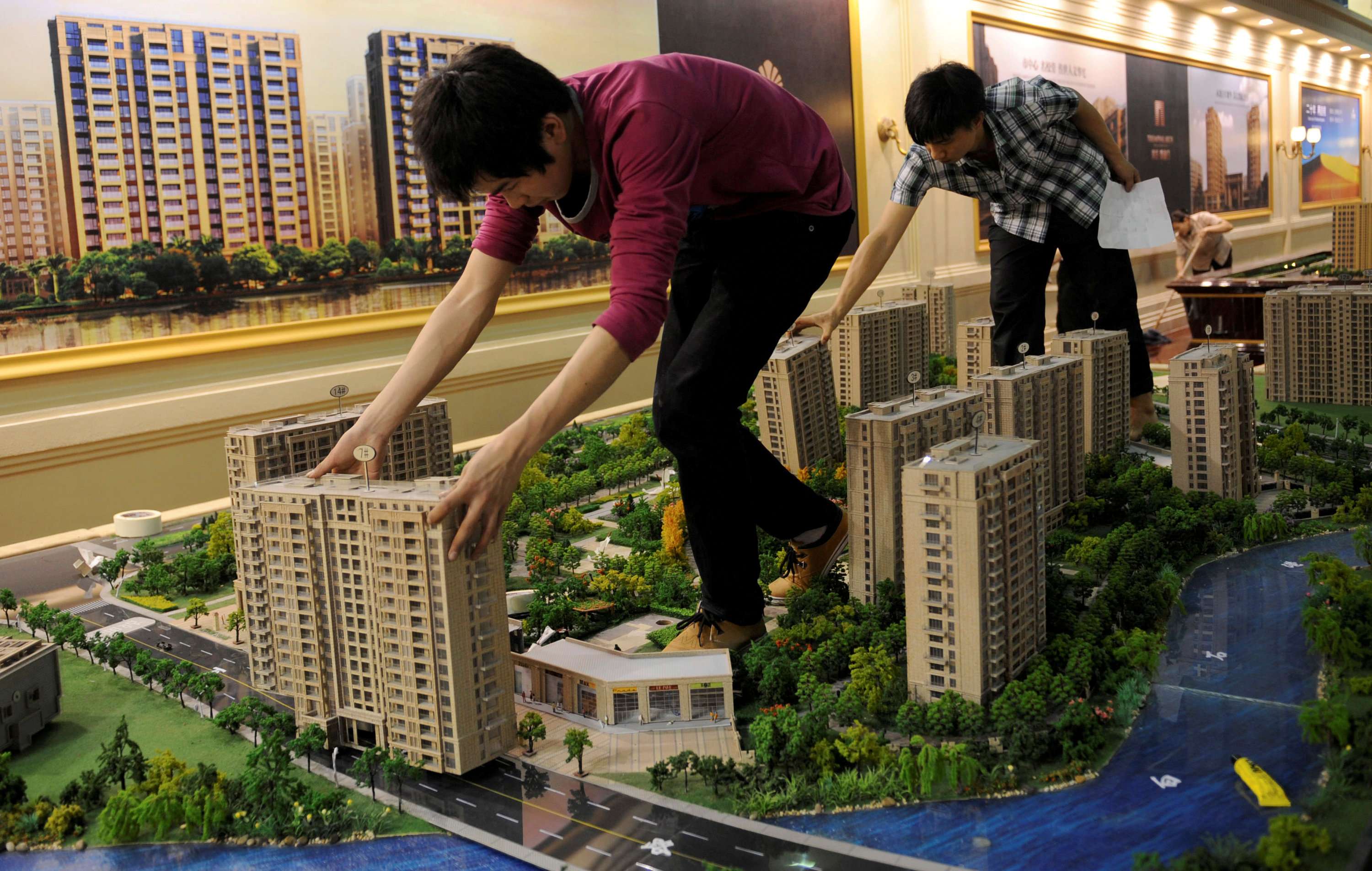 Employees set up model apartments as they prepare for a property exhibition in Hangzhou, Zhejiang province. Photo: Reuters