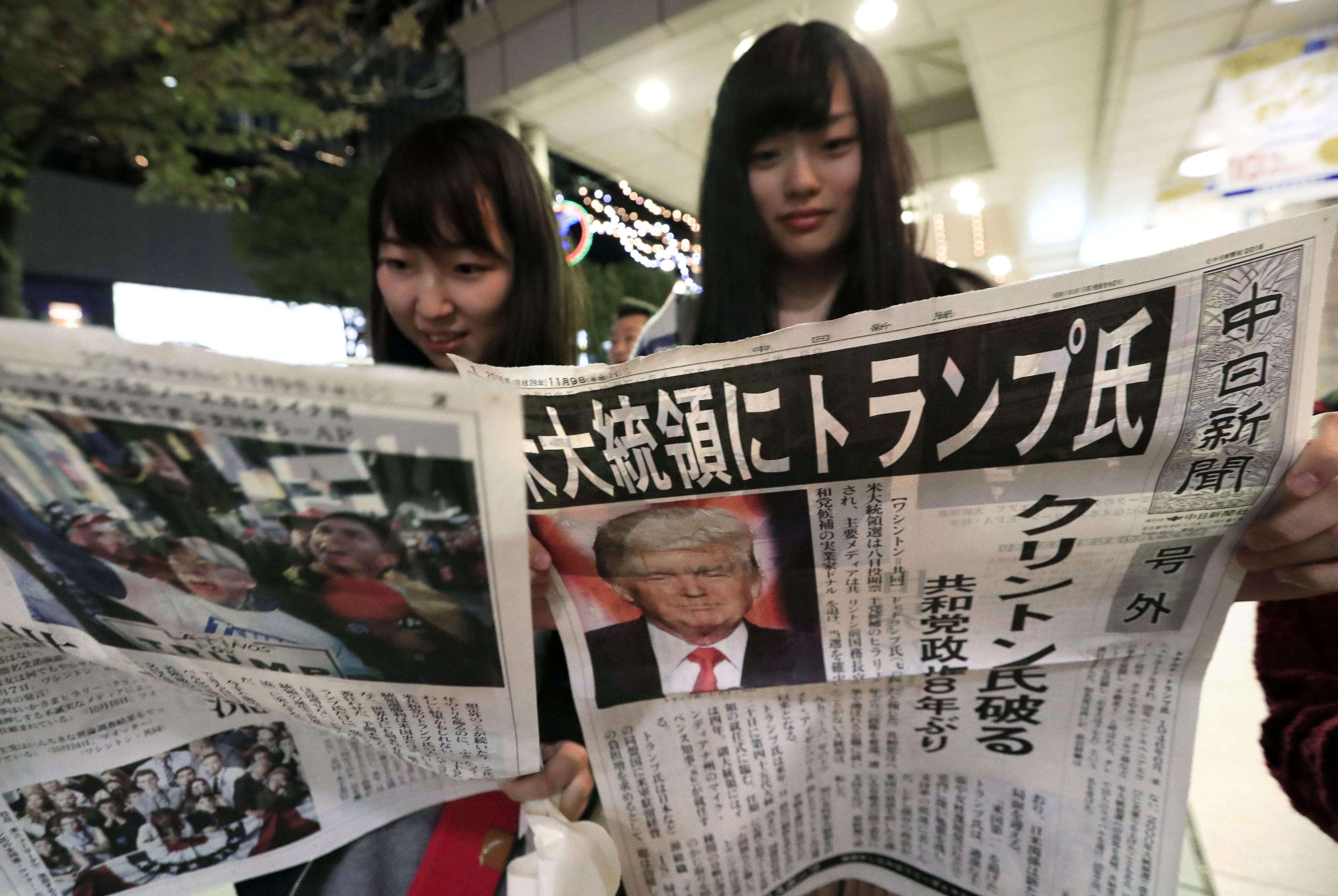 Women read about Donald Trump’s victory in the US presidential election, in Nagoya in central Japan on Wednesday. Photo: Kyodo
