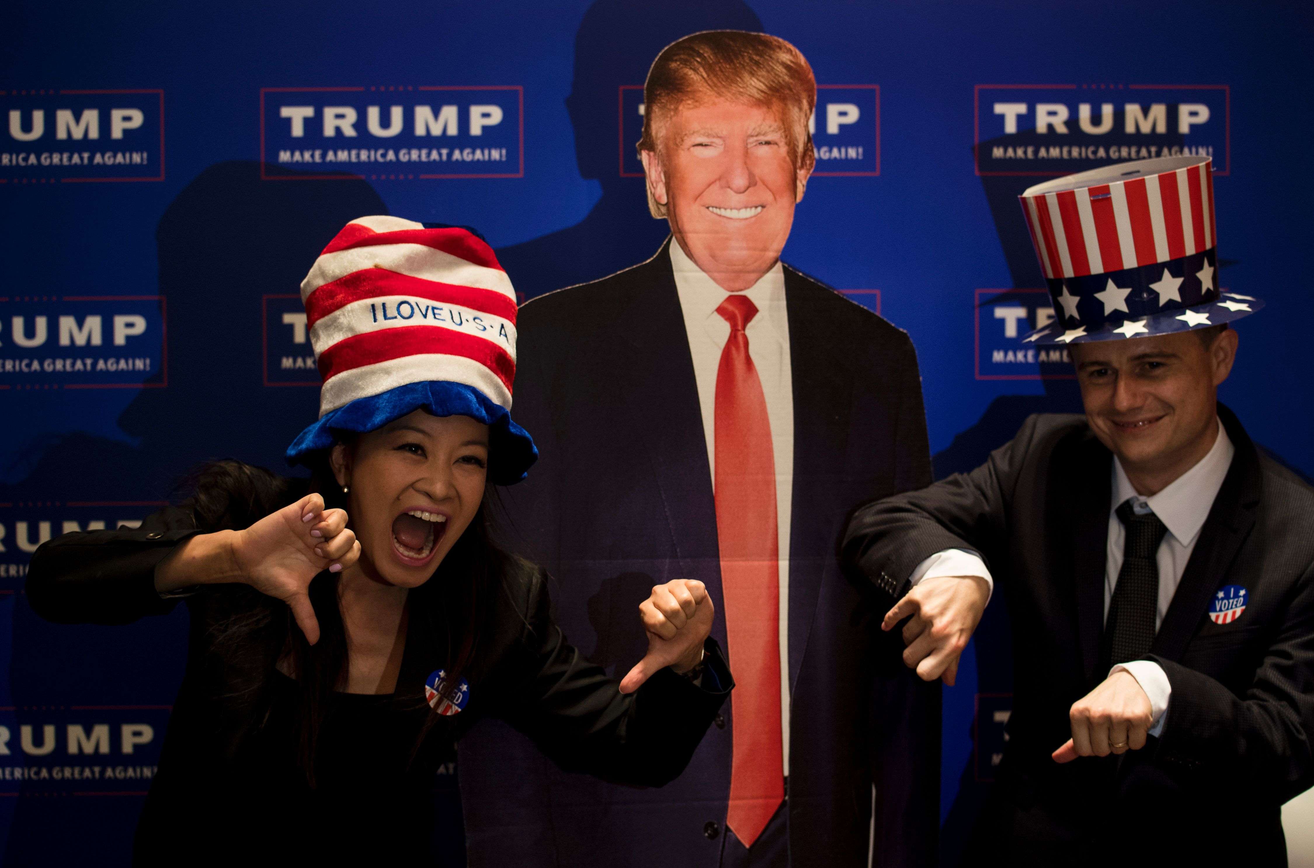 A couple poses next to a cardboard cutout of US presidential candidate Donald Trump during an election event organised by the US consulate in Shanghai on Wednesday. Photo: AFP