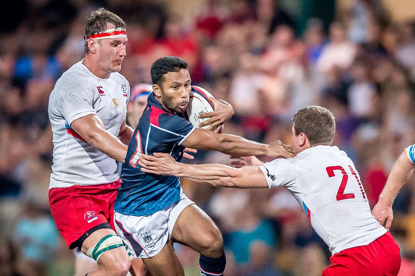 Upcoming Hong Kong scrum half Jason Jeyam is swamped in his side’s loss to Russia in the Cup of Nations. Photos: SCMP Pictures