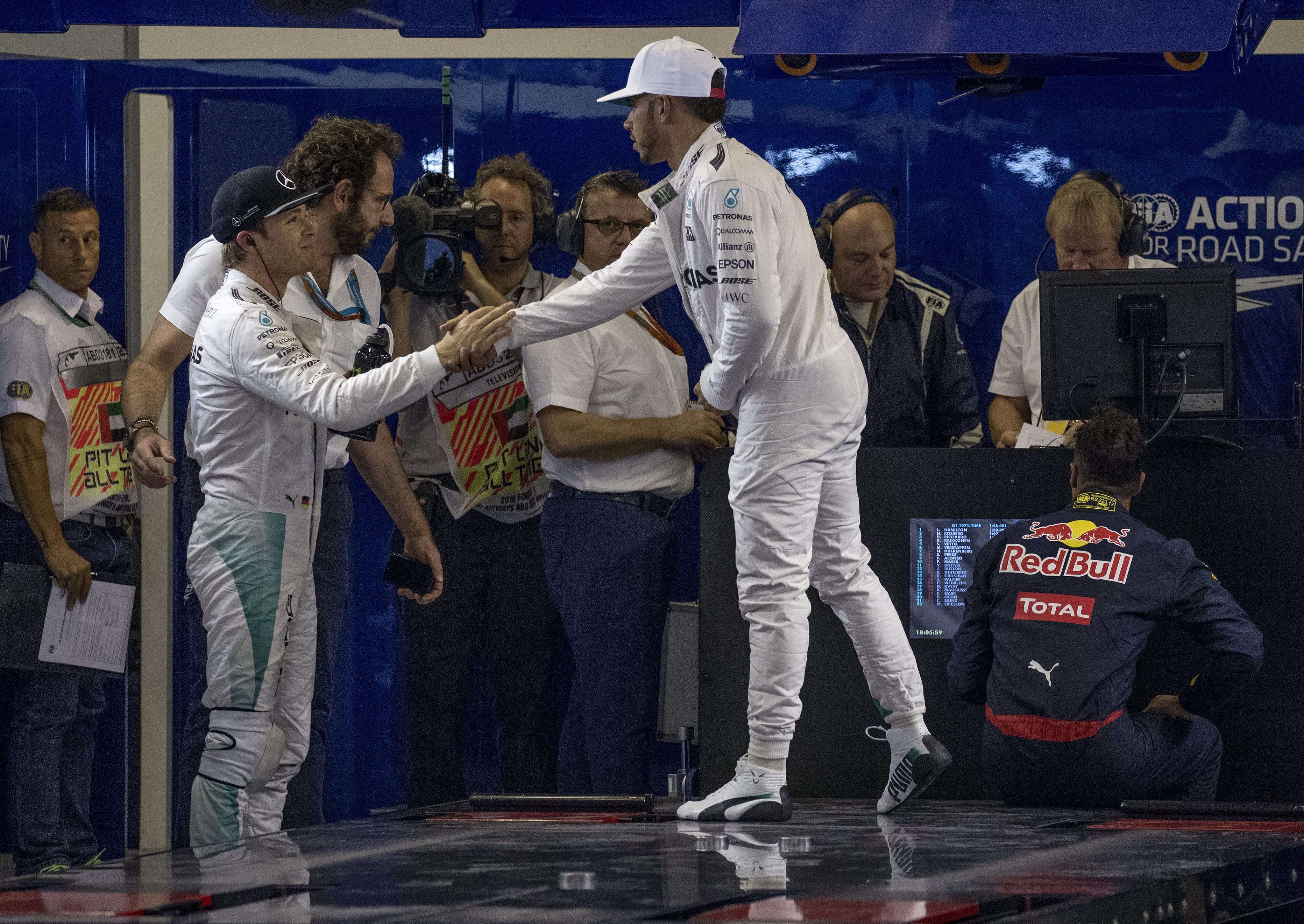 Mercedes teammates Nico Rosberg (left) and Lewis Hamilton shake hands after qualifying for the Abu Dhabi Grand Prix. Photo: EPA