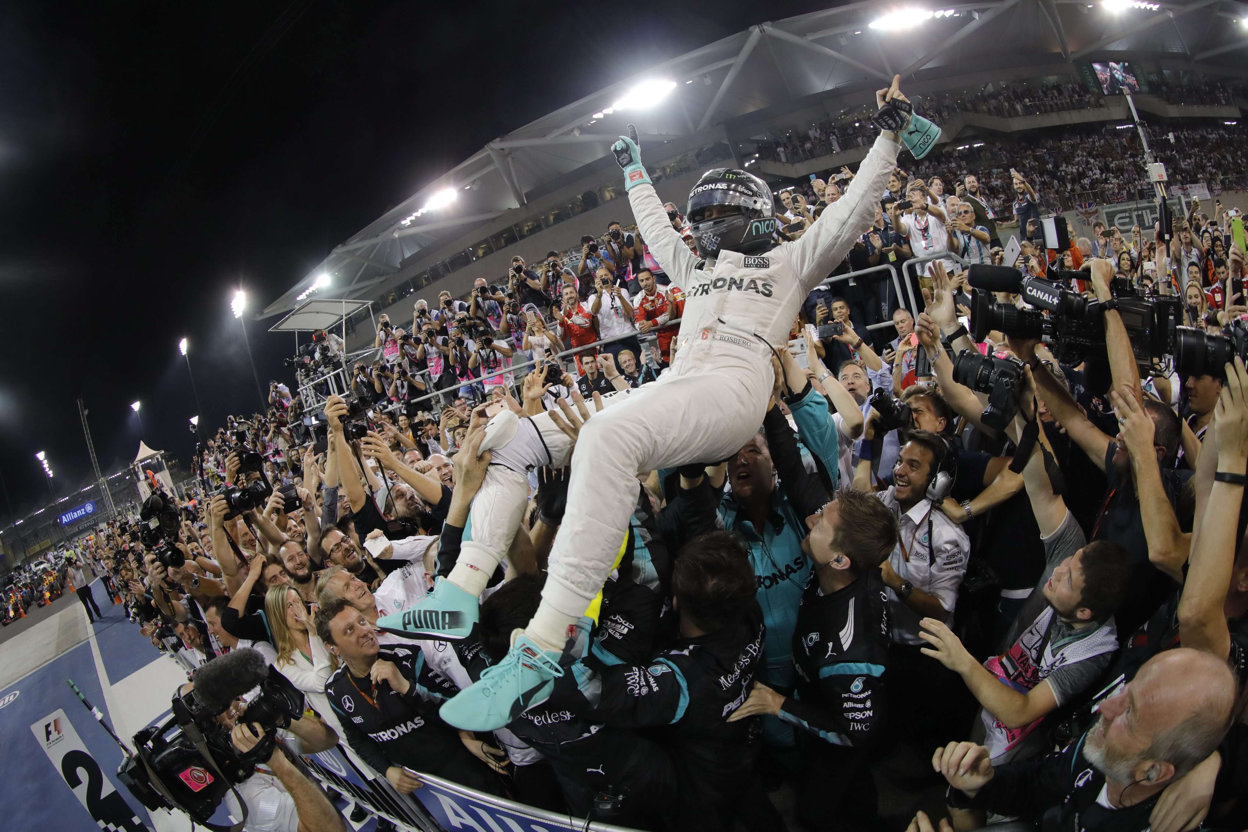 German Formula One driver Nico Rosberg celebrates his world title with his crew after finishing second in the Abu Dhabi Grand Prix in his Mercedes. Photo: EPA
