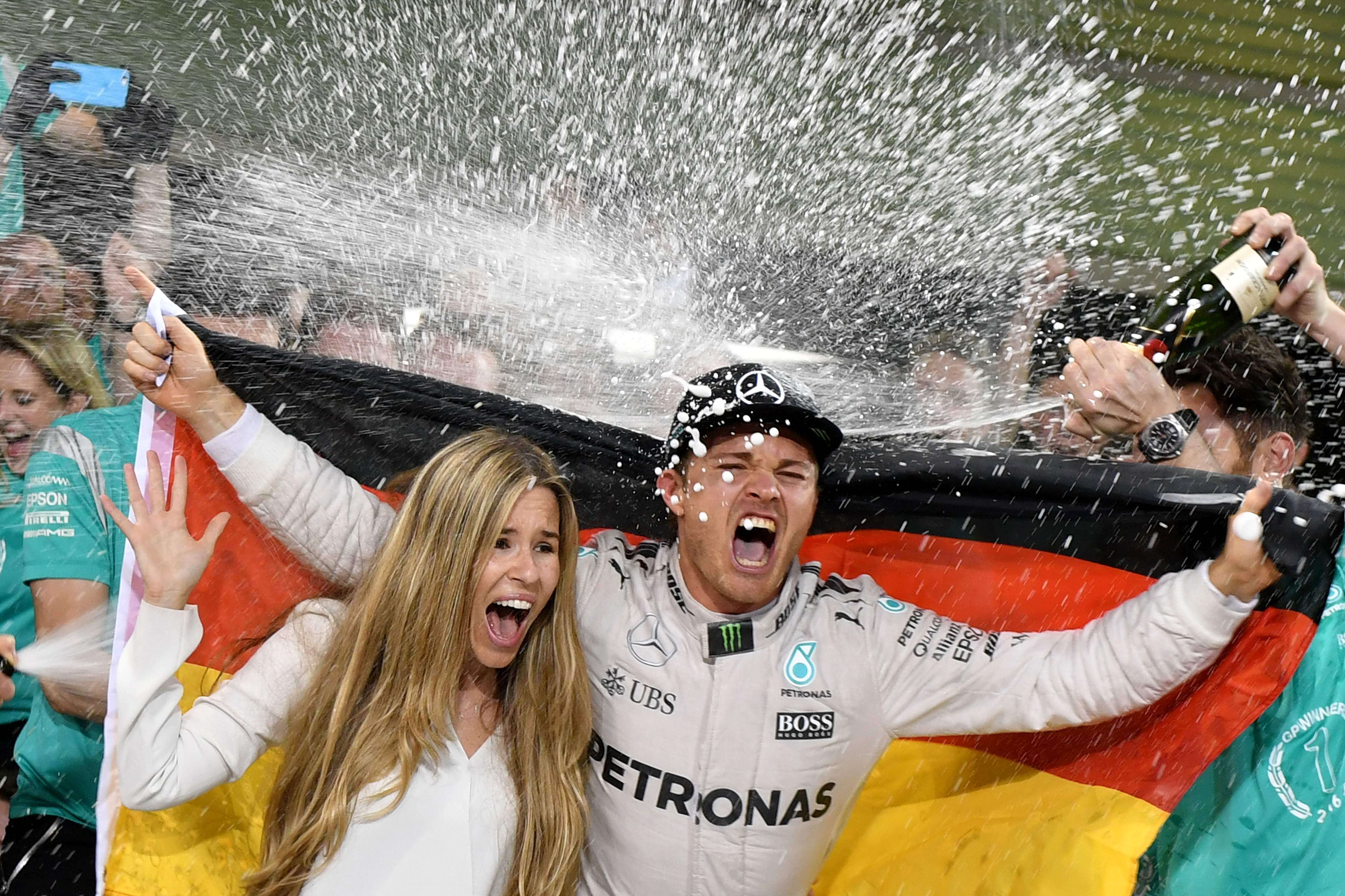 Nico Rosberg and his wife Vivian Sibold get the champagne treatment as they celebrate Rosberg winning the Formula One world championship at the season-ending Abu Dhabi Grand Prix. German fans won’t see their new world champion on home soil next season. Photo: AFP