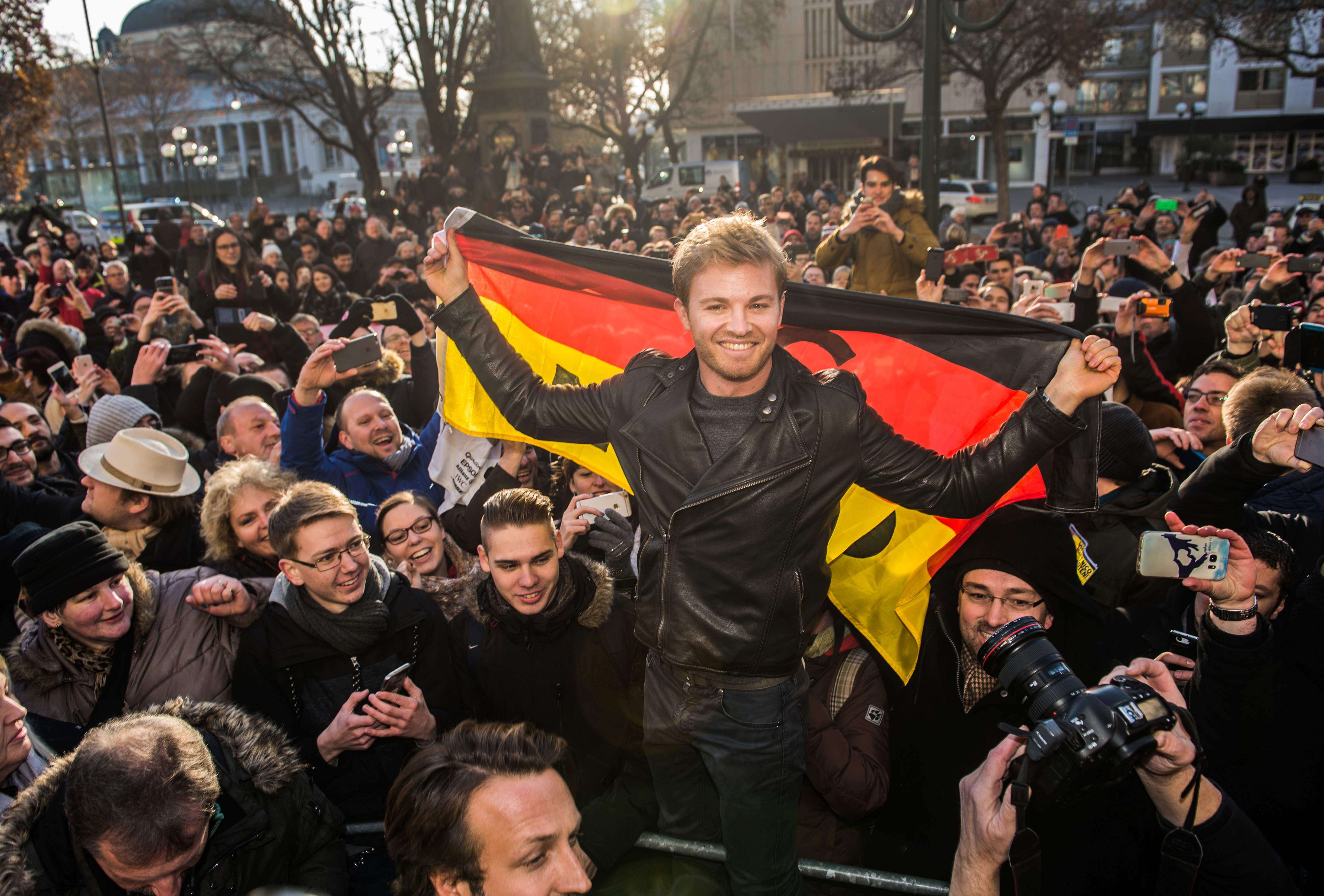 New Formula One world champion Nico Rosberg with a German flag as he meets fans in his home town of Wiesbaden in western Germany. Photo: AFP