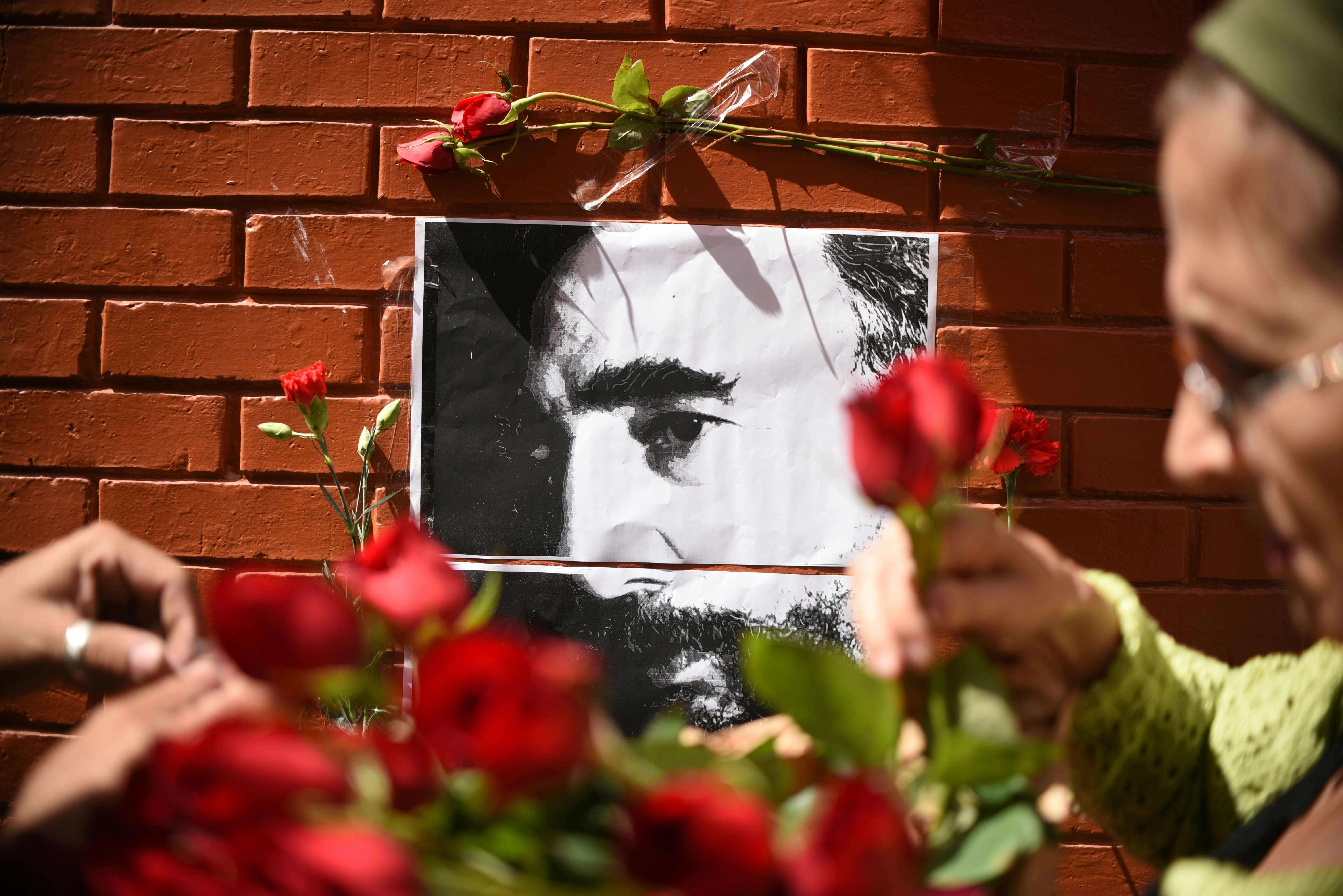 People place flowers next to a portrait of Fidel Castro outside the Cuban embassy in Guatemala City. Photo: AFP