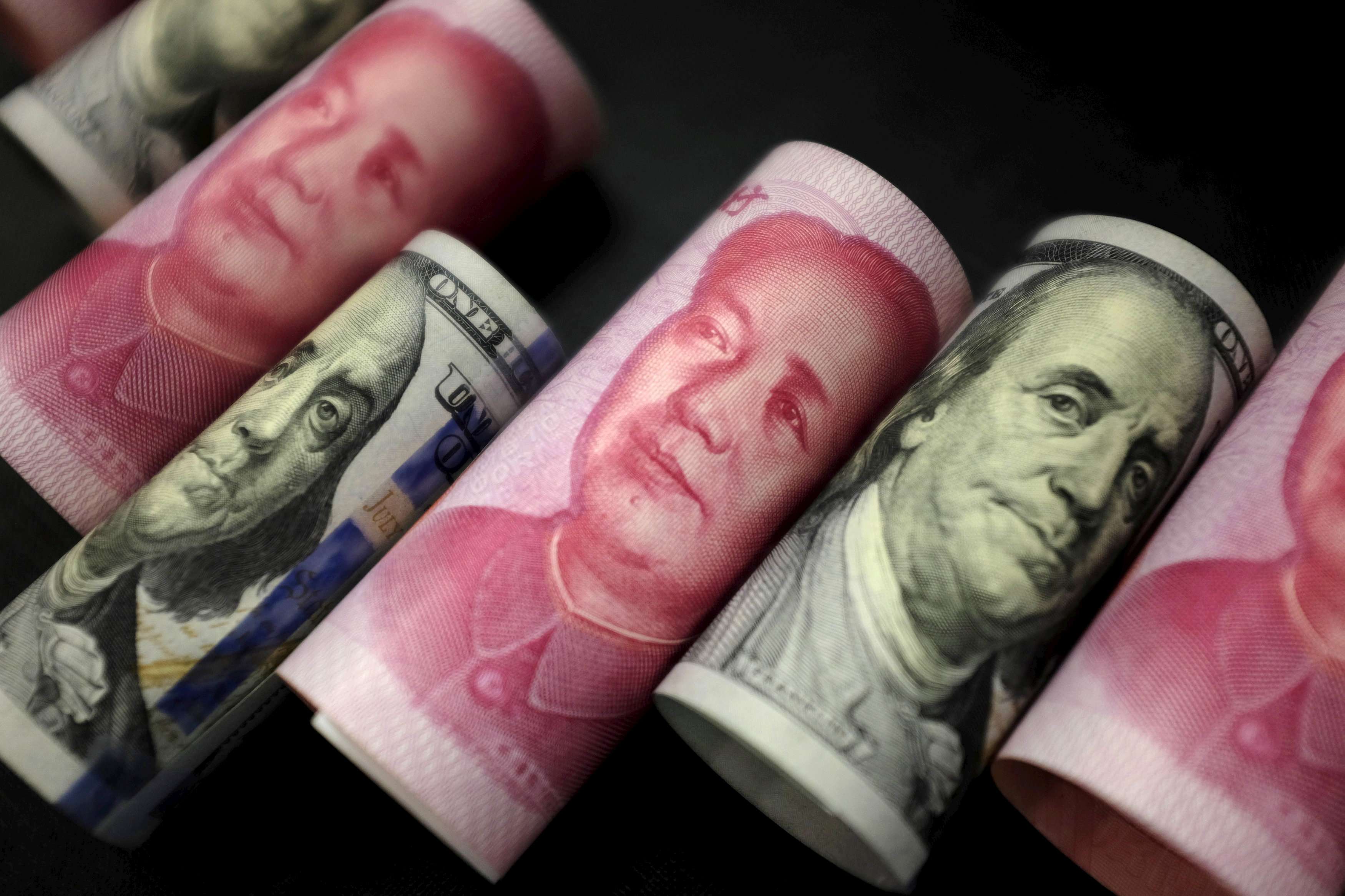 The PBOC will likely confront further downside pressure on the yuan when the US$50,000 annual quota on yuan conversion refreshes in January. Photo: Reuters