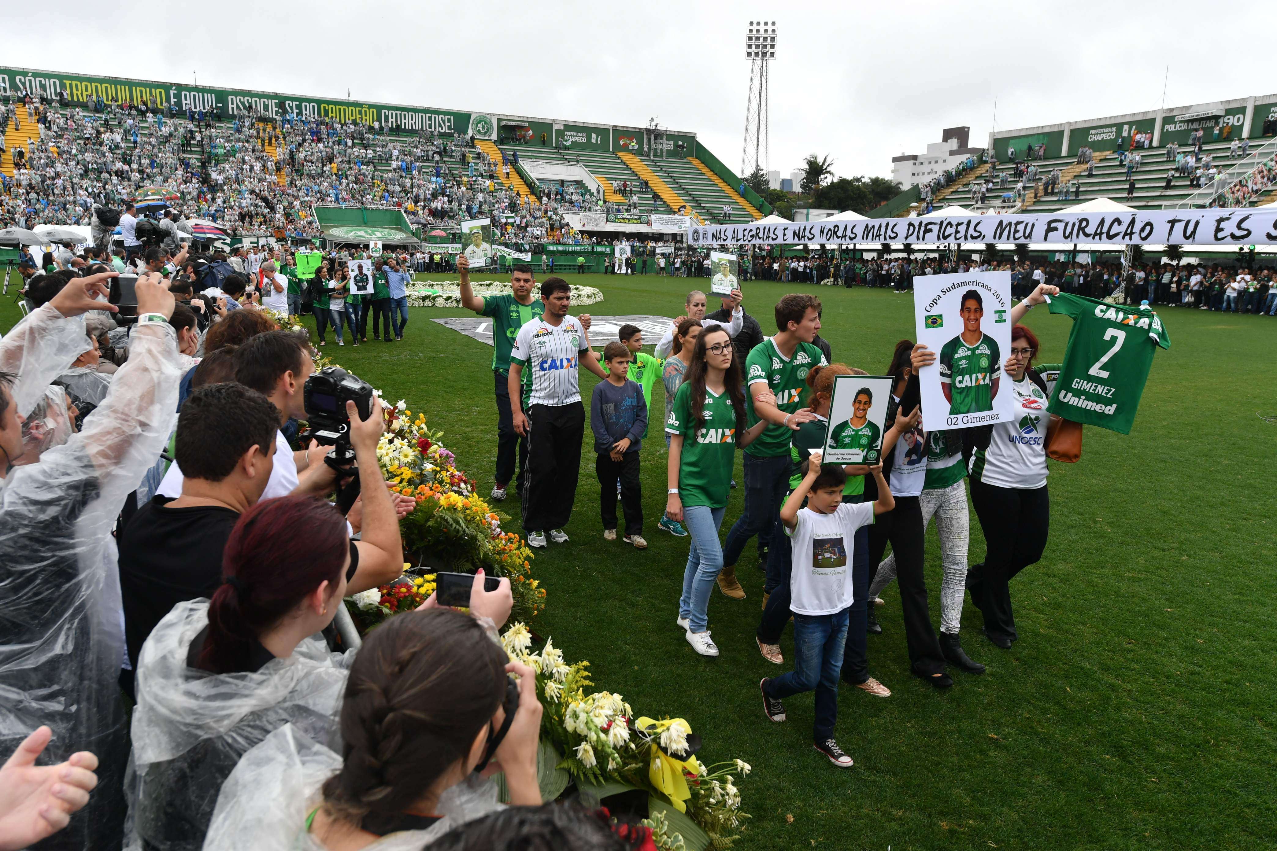 Relatives of the members of Chapecoense football club killed in a plane crash in Colombia enter the field during a funeral ceremony at the stadium in Chapeco, Santa Catarina, southern Brazil. Photo: AFP