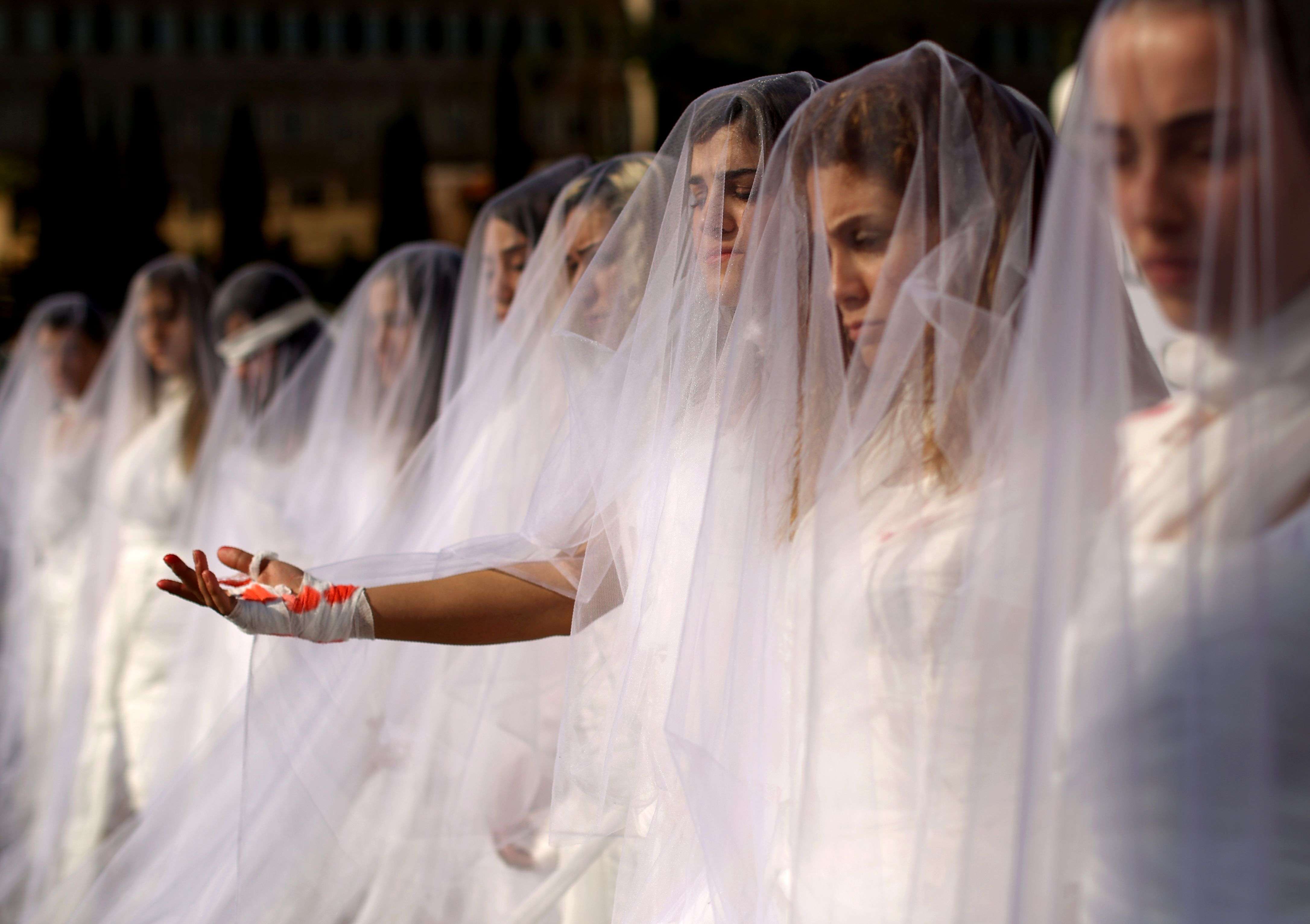 Activists from a Lebanese NGO dress as injured brides in downtown Beirut this month. They were protesting against a law that shields rapists from prosecution on the condition that they marry their victim. Photo: AFP