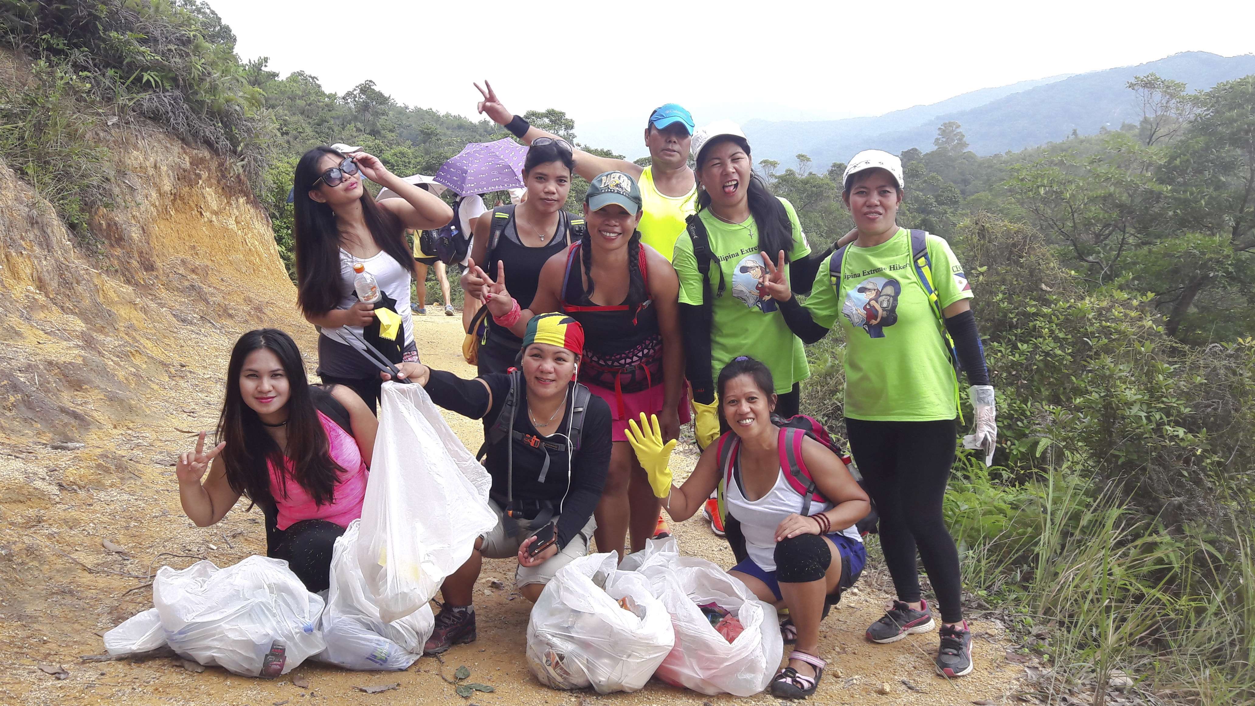 Liza Avelino (centre in cap and pink shorts) and her cleanup team.
